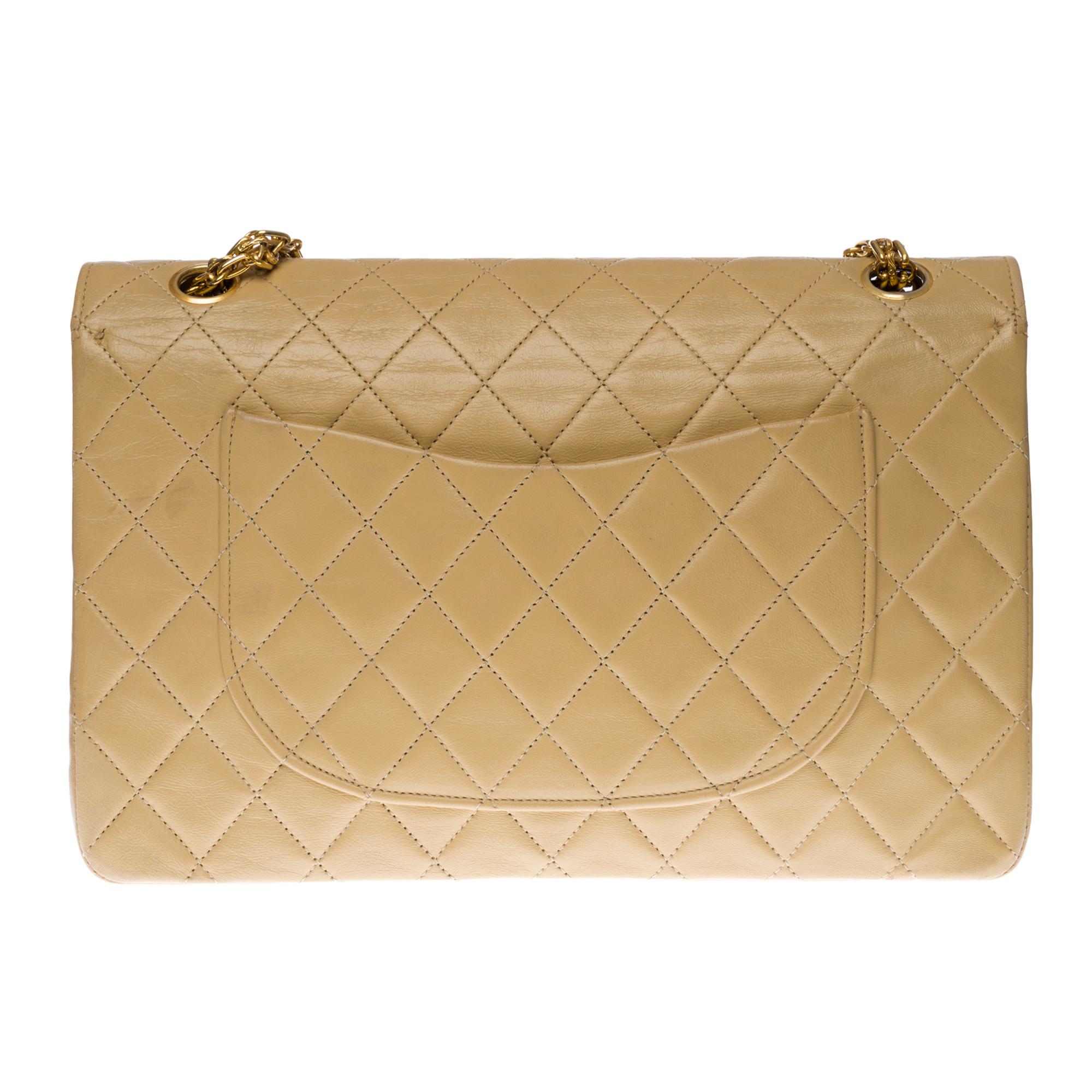 Beautiful Chanel Timeless/Classic handbag with double flap in beige quilted lambskin, gold-plated metal hardware, a Mademoiselle gold-plated metal chain handle allowing a hand or shoulder support

A patch pocket on the back of the bag
Inner lining