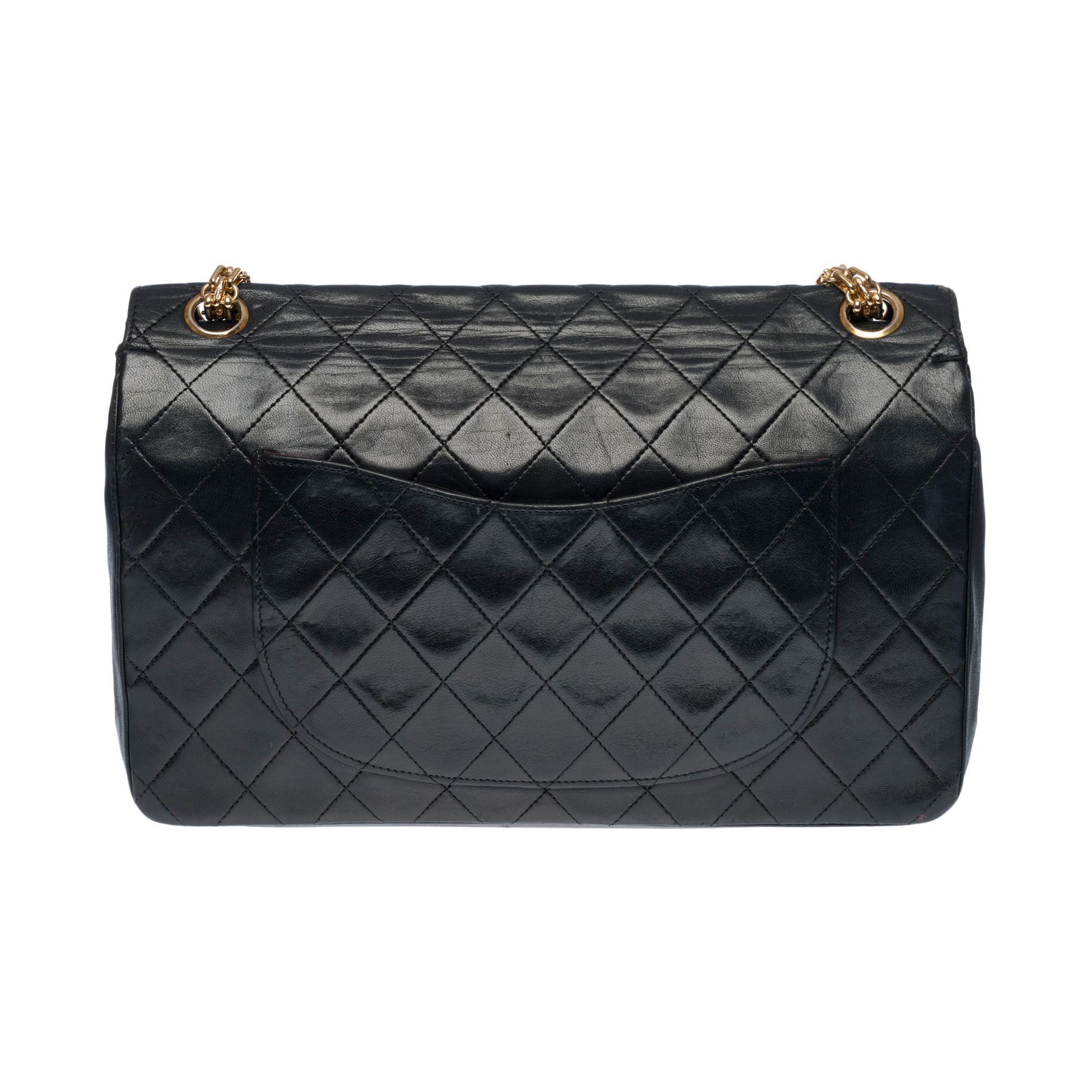 Beautiful Chanel Timeless/Classic double flap shoulder bag in black quilted lambskin leather, gold-plated metal hardware, a Mademoiselle gold-plated metal chain handle for a hand or shoulder support

A patch pocket on the back of the bag
Inner