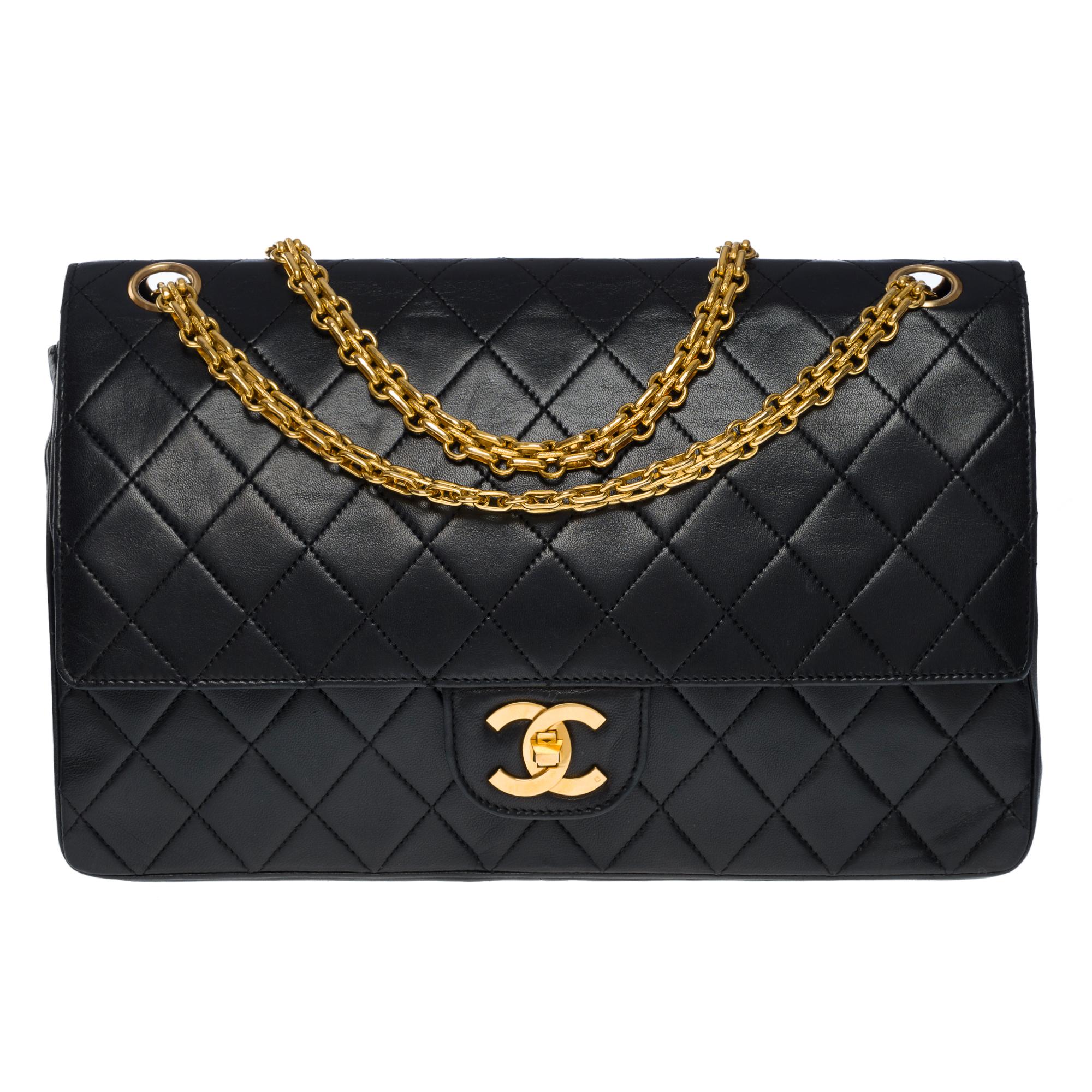 Beautiful Chanel Timeless/Classic 27 cm double flap shoulder bag in black quilted lambskin, gold metal hardware, a Mademoiselle gold metal chain handle for a shoulder and crossbody carry
Backpack pocket
Closure by flap, Mademoiselle clasp signed CC