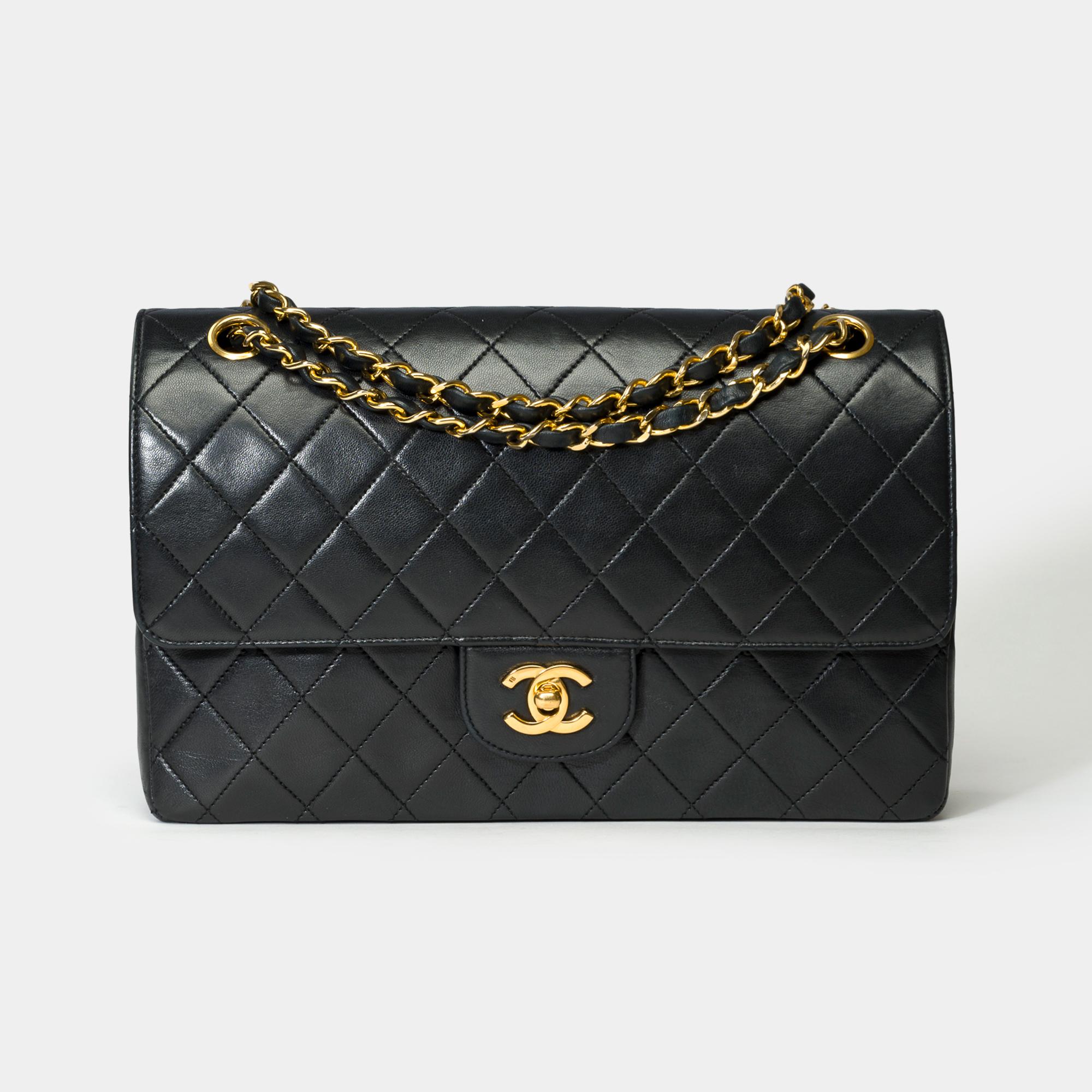 Superb​ ​Chanel​ ​Timeless/Classic​ ​double​ ​flap​ ​shoulder​ ​bag​ ​in​ ​black​ ​quilted​ ​lambskin,​ ​gold​ ​metal​ ​trim,​ ​a​ ​gold​ ​metal​ ​chain​ ​handle​ ​interlaced​ ​with​ ​black​ ​leather​ ​for​ ​a​ ​shoulder​ ​or​ ​crossbody​