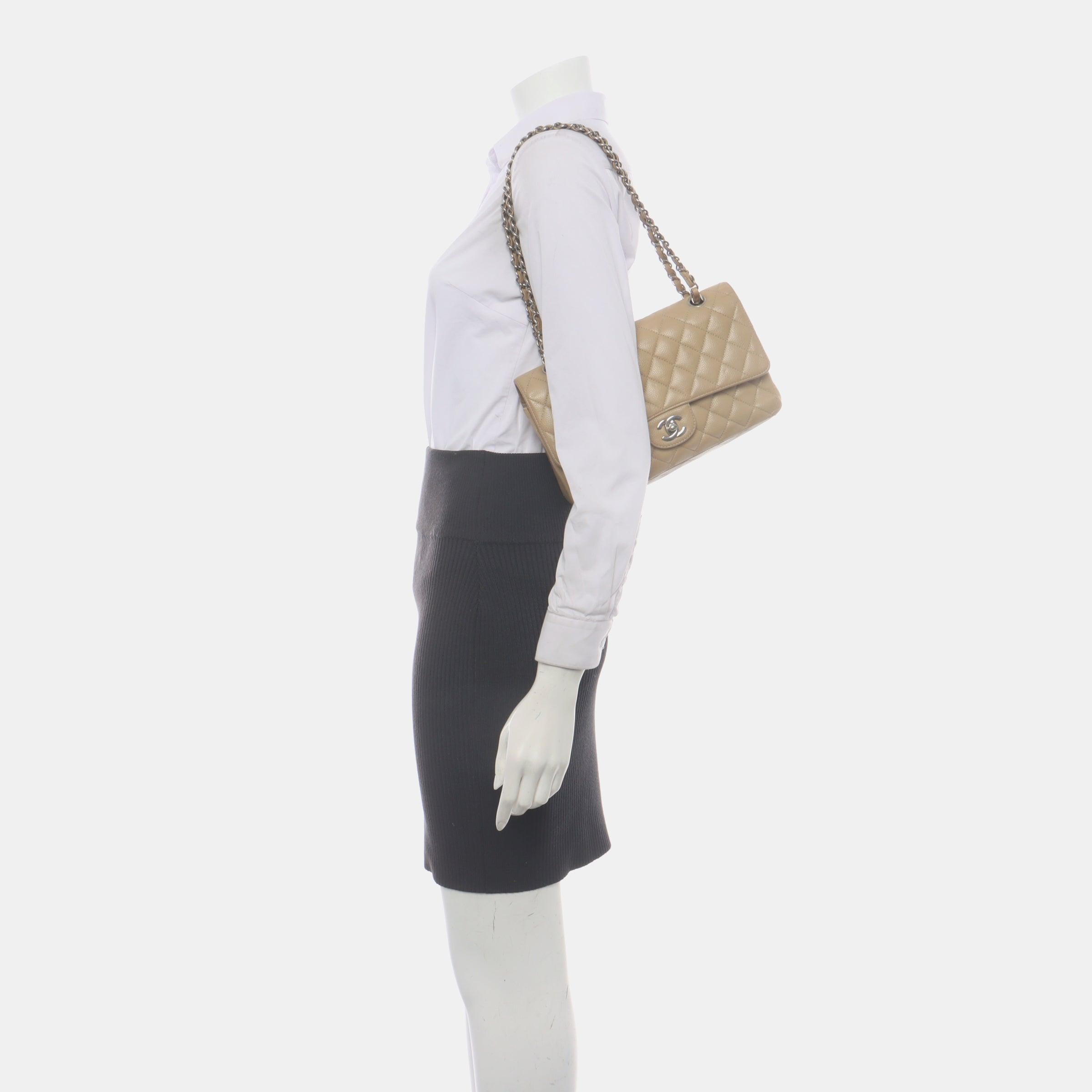 Chanel Timeless Classic Flap Medium Beige Caviar Leather Silver Hardware, 2005-2006
 These are professional photos of the actual bag .
 This one-of-a-kind Chanel Classic Flap Vintage bag exudes sophistication and timeless elegance. Crafted from