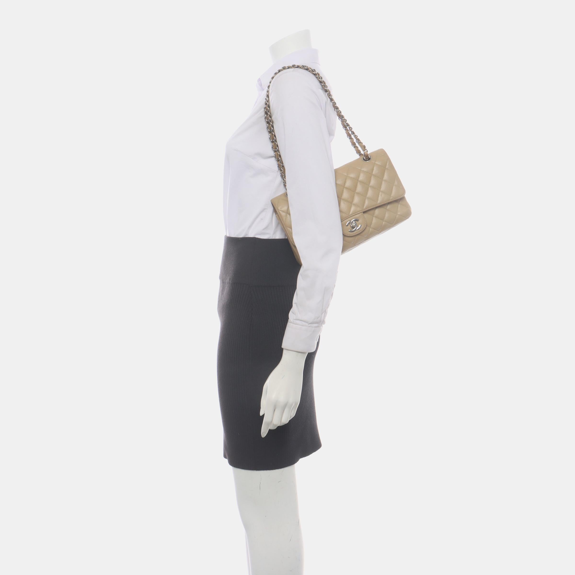 This one-of-a-kind Chanel Classic Flap Vintage bag exudes sophistication and timeless elegance. Crafted from luxurious beige caviar leather.

CONDITION: VERY GOOD

This preloved authentic Chanel bag is in very good condition with light stains all