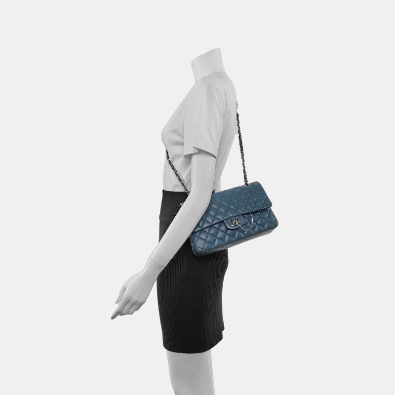Chanel Timeless Classic Flap Medium Misty Blue Lambskin Leather Silver Hardware, 2012
 These are professional photos of the actual bag.
 CONDITION: VERY GOOD ORIGINAL CONDITION
 This preloved authentic Chanel bag is in very good condition. Rubbing
