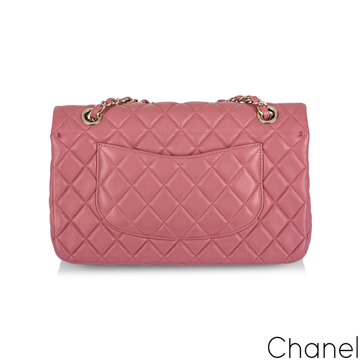 A Timeless Classic Chanel Valentine 2014 Medium Flap handbag. The exterior of this medium Timeless Classic is crafted with a beautiful dusty rose lambskin leather with gold tone hardware. The medium flap is designed with the signature diamond style