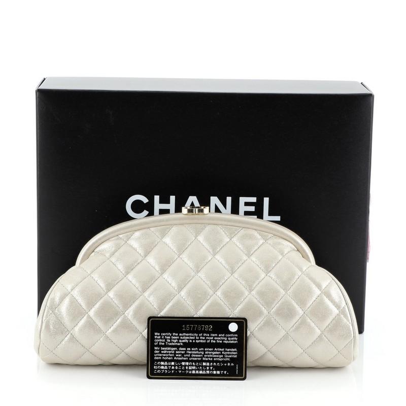 The Chanel Timeless Clutch Iridescent Caviar, crafted from neutral quilted caviar leather, features oval top frame silhouette and gold-tone hardware. Its CC kiss-lock closure opens to a neutral leather interior with side zip pocket. Authenticity