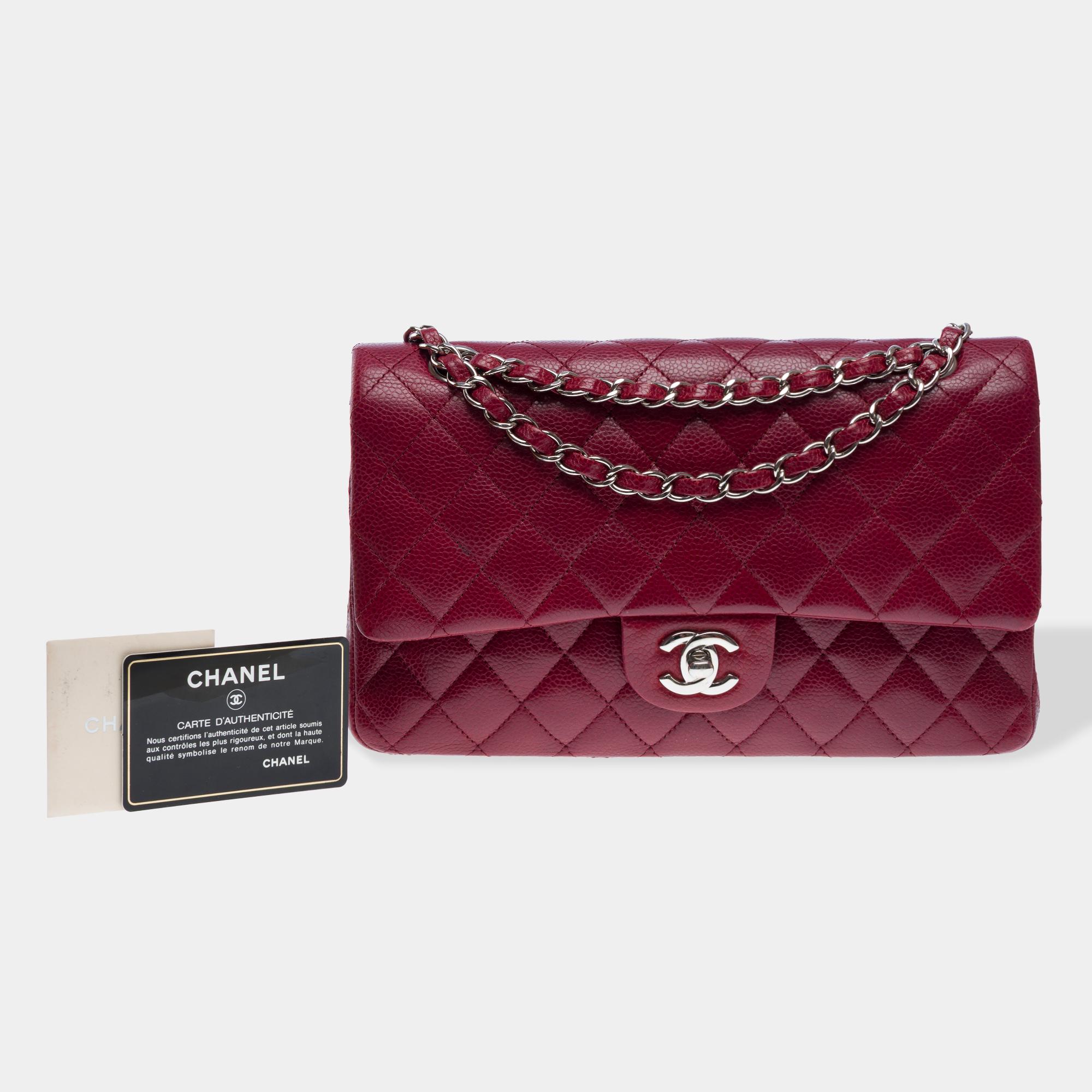 Magnificent​ ​Chanel​ ​bag​ ​with​ ​double​ ​flap​ ​in​ ​quilted​ ​burgundy​ ​leather,​ ​trim​ ​in​ ​silver​ ​metal,​ ​handle​ ​in​ ​silver​ ​metal​ ​interwoven​ ​with​ ​metallic​ ​burgundy​ ​leather,​ ​allowing​ ​it​ ​to​ ​be​ ​carried​ ​by​ ​hand​
