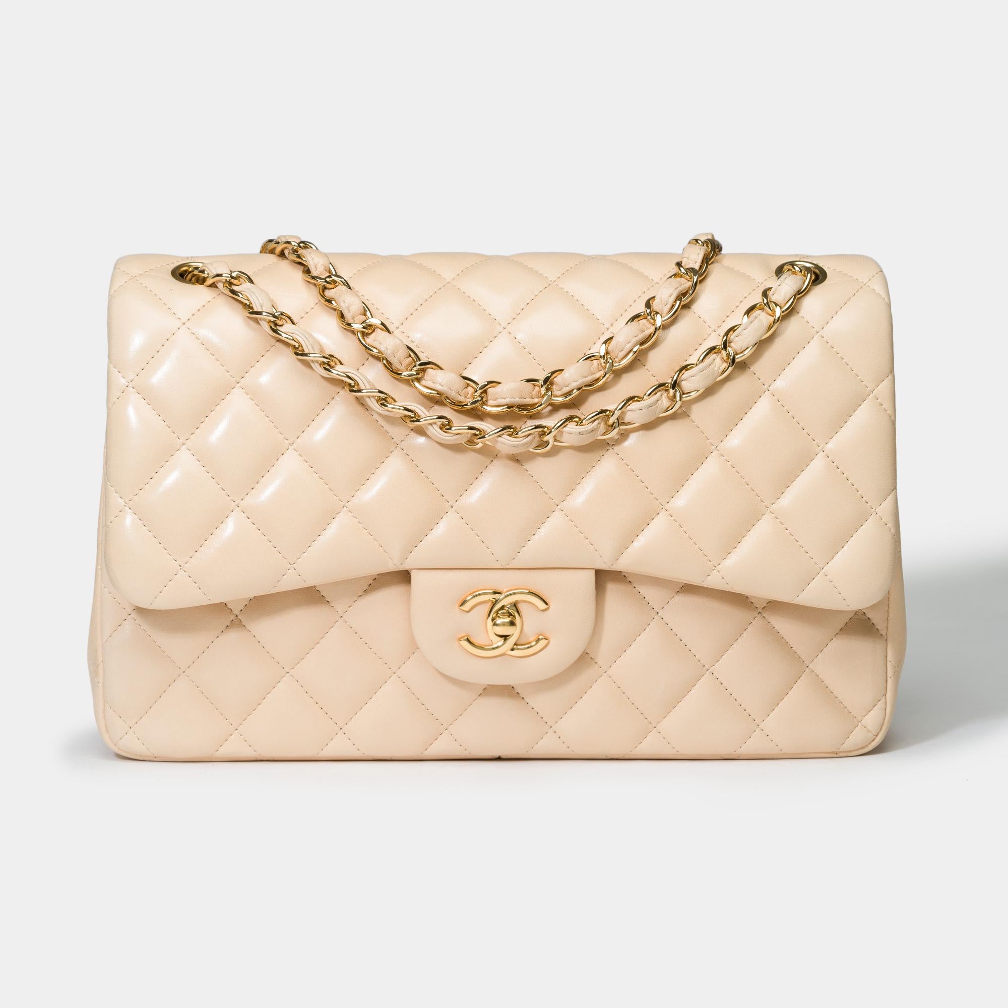 Stunning​ ​Chanel​ ​Timeless​ ​Jumbo​ ​double​ ​flap​ ​shoulder​ ​bag​ ​in​ ​beige​ ​quilted​ ​lambskin​ ​leather,​ ​gold​ ​metal​ ​trim,​ ​a​ ​gold​ ​metal​ ​chain​ ​handle​ ​interlaced​ ​with​ ​beige​ ​leather​ ​for​ ​a​ ​hand​ ​or​ ​shoulder​