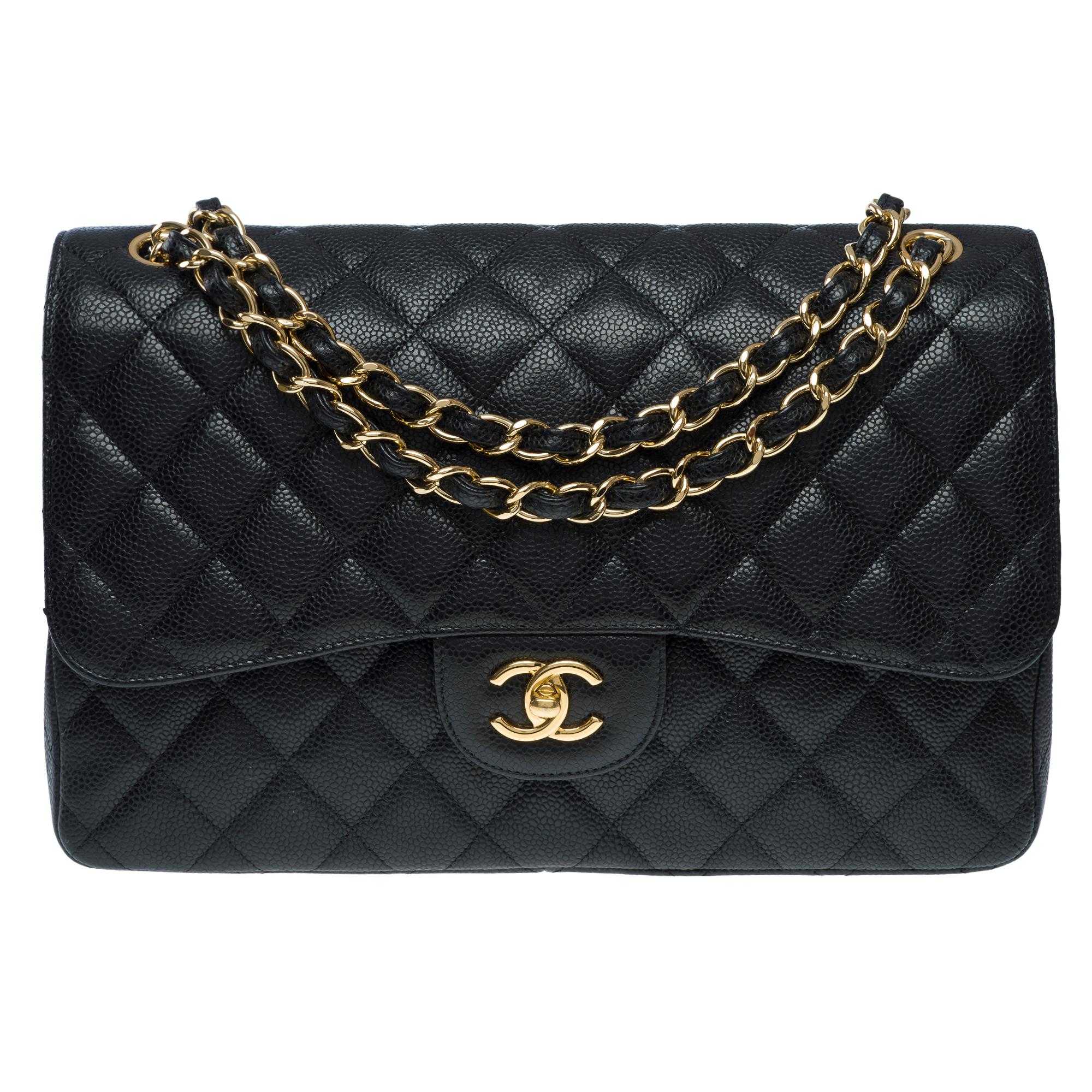 Majestic​ ​Chanel​ ​Timeless​ ​Jumbo​ ​double​ ​flap​ ​shoulder​ ​bag​ ​in​ ​black​ ​quilted​ ​caviar​ ​leather,​ ​gold​ ​metal​ ​trim,​ ​gold​ ​metal​ ​chain​ ​strap​ ​interwoven​ ​with​ ​black​ ​leather​ ​for​ ​carrying​ ​by​ ​hand,​ ​shoulder,​