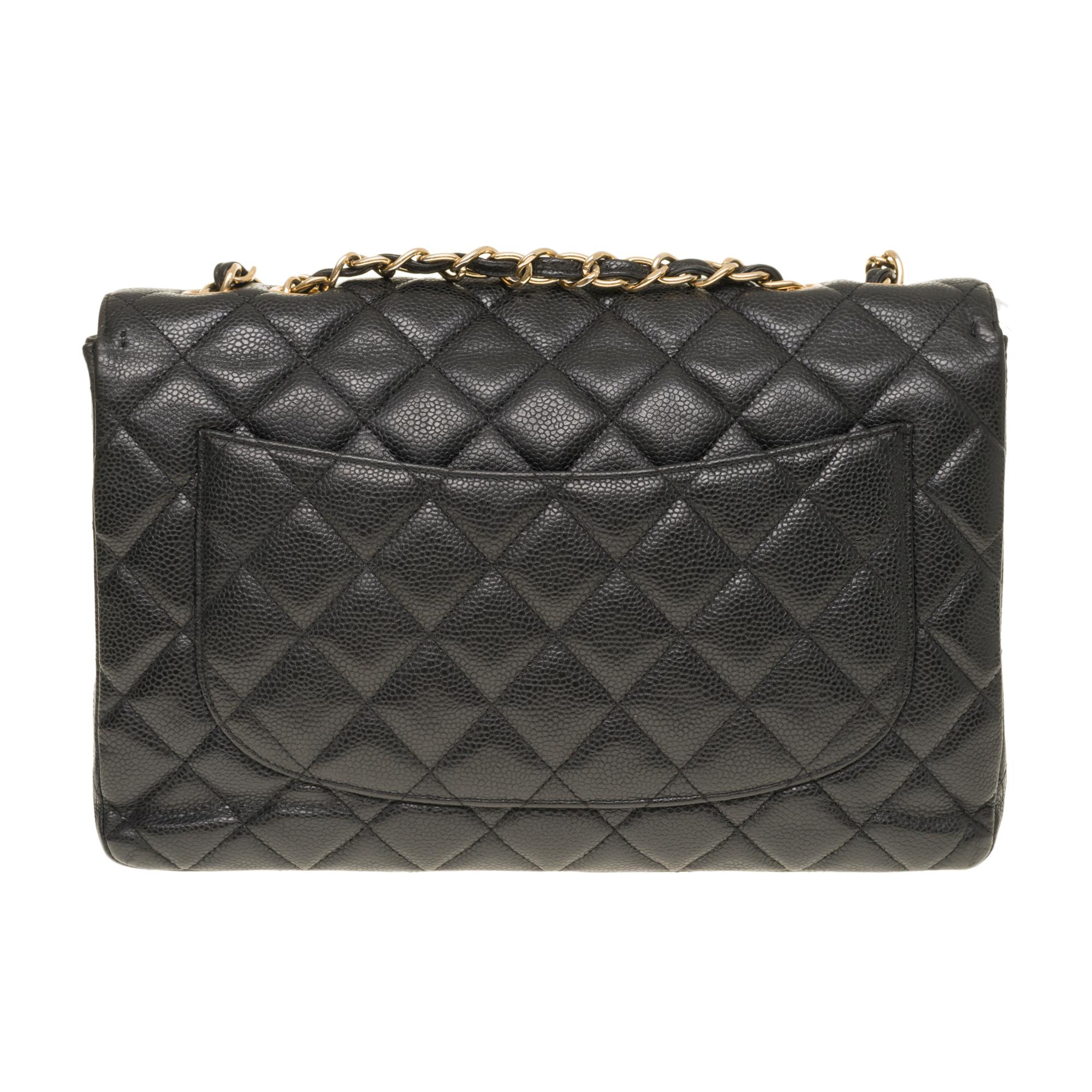 The Majestic Shoulder Bag Chanel Timeless Jumbo Flap bag in black quilted grained leather, gold-tone metal hardware, gold-tone metal chain handle intertwined with black leather allowing a hand or shoulder or shoulder strap

Gilded metal logo closure
