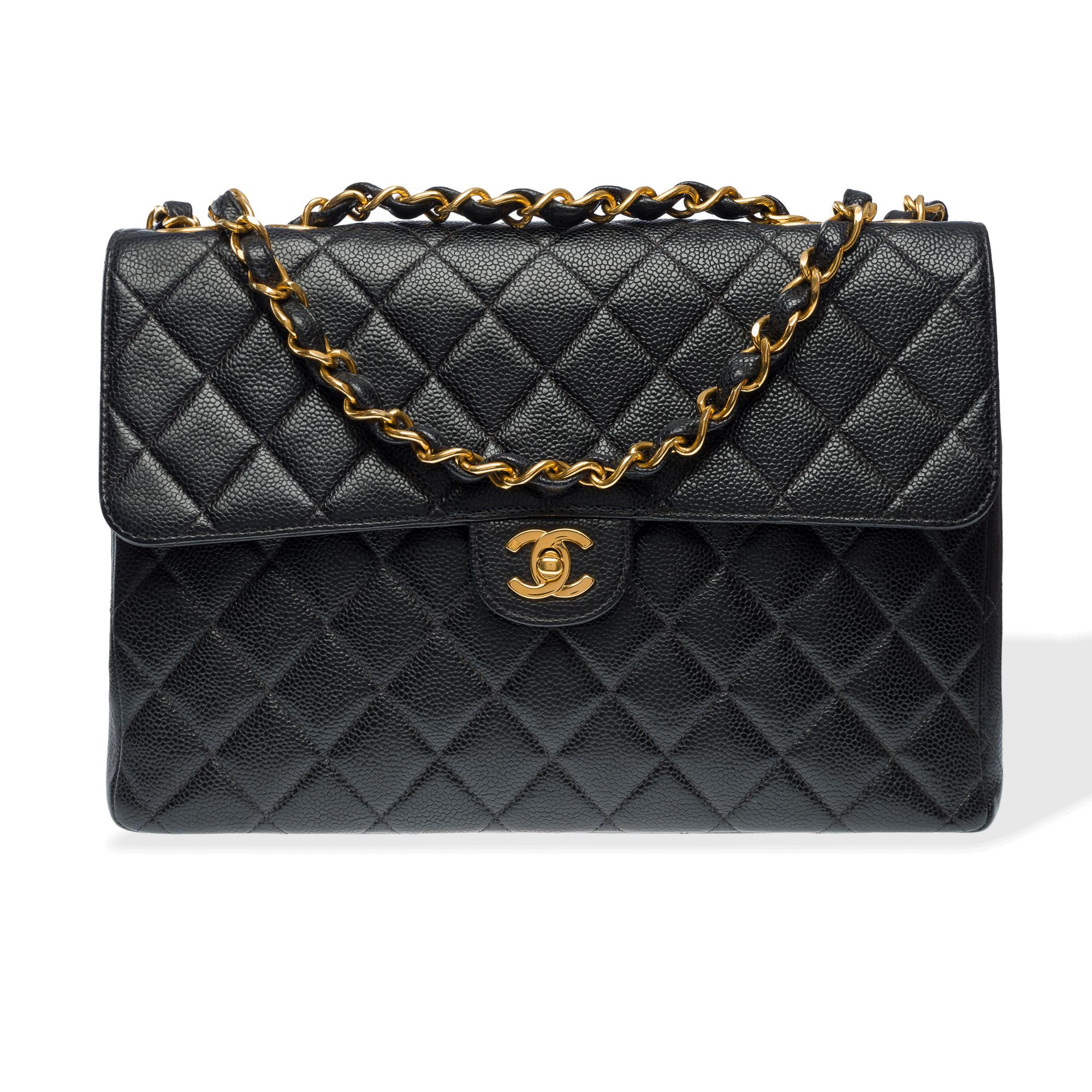 Majestic​ ​Chanel​ ​Timeless/Classic​ ​Jumbo​ ​single​ ​flap​ ​shoulder​ ​bag​ ​in​ ​black​ ​quilted​ ​caviar​ ​leather,​ ​with​ ​gold​ ​metal​ ​trim,​ ​a​ ​gold​ ​metal​ ​interlaced​ ​chain​ ​handle​ ​with​ ​black​ ​leather​ ​for​ ​shoulder​ ​or​