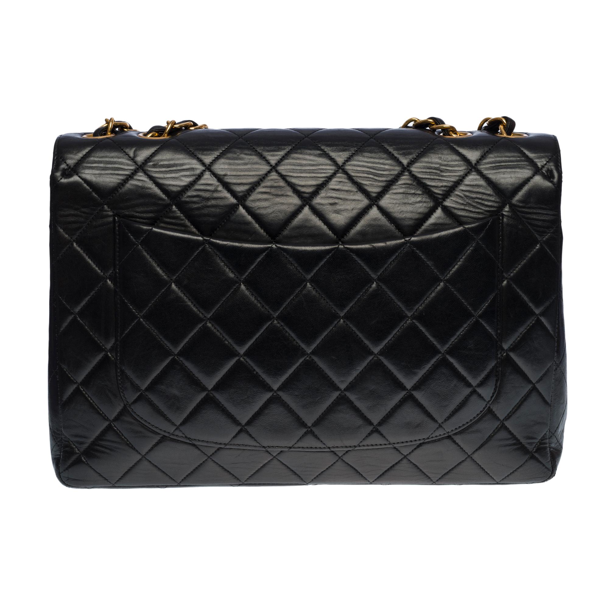 The Majestic Chanel Timeless Jumbo Single Flap shoulder bag in black quilted lambskin, gold-plated metal hardware, a gold-plated metal chain handle interlaced with black leather for a hand and shoulder carry
 
A patch pocket on the back of the
