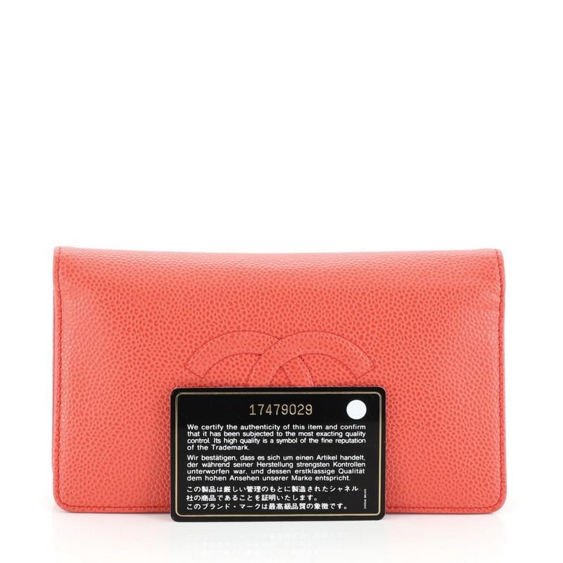 This Chanel Timeless L-Yen Wallet Caviar Long, crafted from red caviar leather, features embossed CC logo and silver-tone hardware. It opens to a red leather interior with multiple card slots, long flat pockets and zip pocket. Hologram sticker