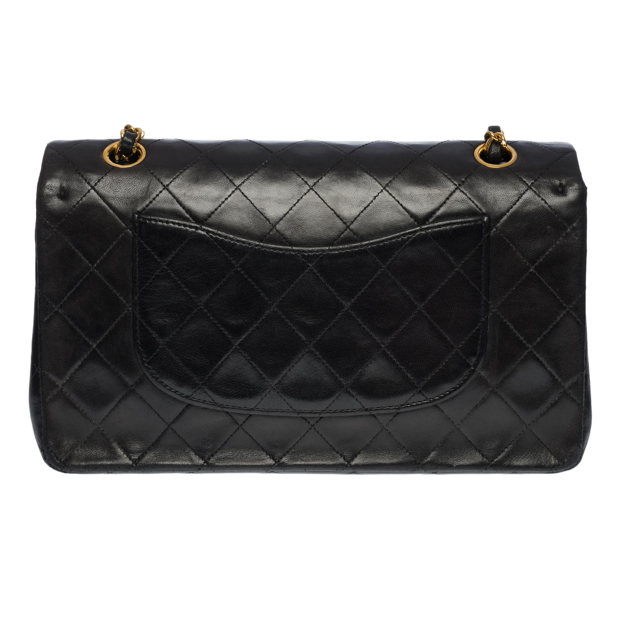 The coveted Chanel Timeless Medium 25 double flap shoulder bag s in black quilted lambskin, gold-tone metal hardware, gold-tone metal chain interwoven with black leather for a shoulder and shoulder strap

Backpack pocket
Flap closure, gold-tone CC