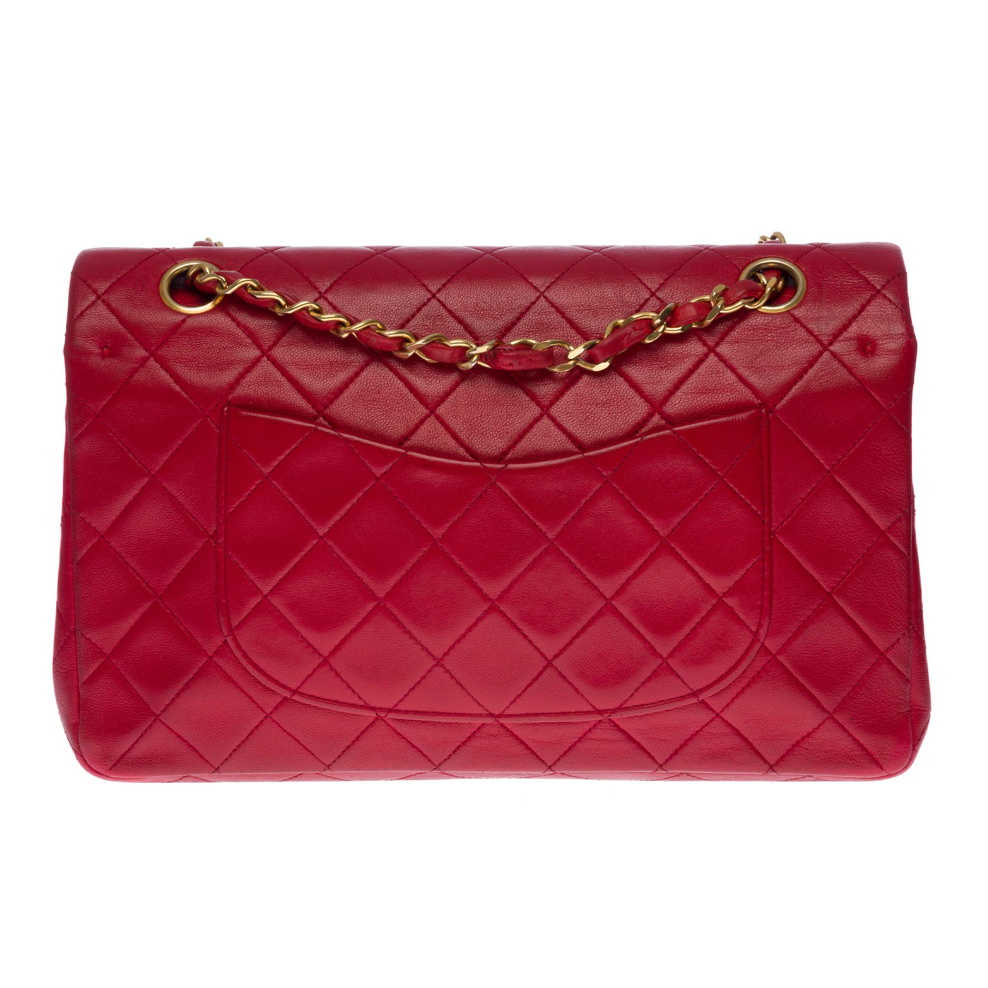 Gorgeous Chanel Timeless Medium Bag with double flap in bright red quilted lambskin leather, gold-tone metal hardware, gold-tone metal chain intertwined with red leather for shoulder support.
Pocket on the back of the bag.
Flap closure, gold-tone CC