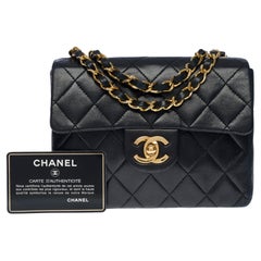 Used Chanel Timeless Mini Square shoulder Flap bag in black quilted lambskin, GHW