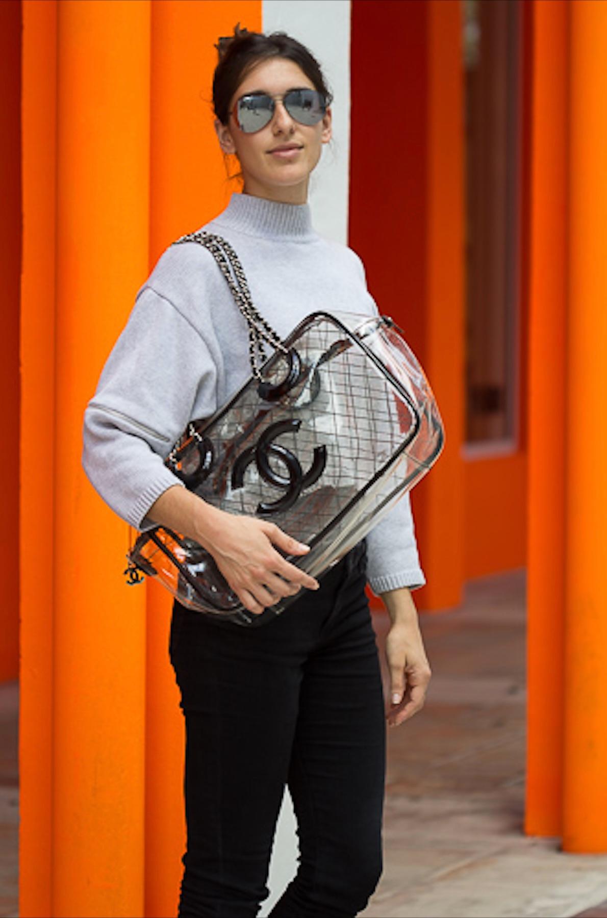 Year 1991  


As seen on Olivia Culpo! Unique vintage extra large Chanel transparent tote made of PVC and lined with patent leather. Features silver hardware, CC logo zipper detail, diamond stitching, patent leather thin interwoven classic chain,