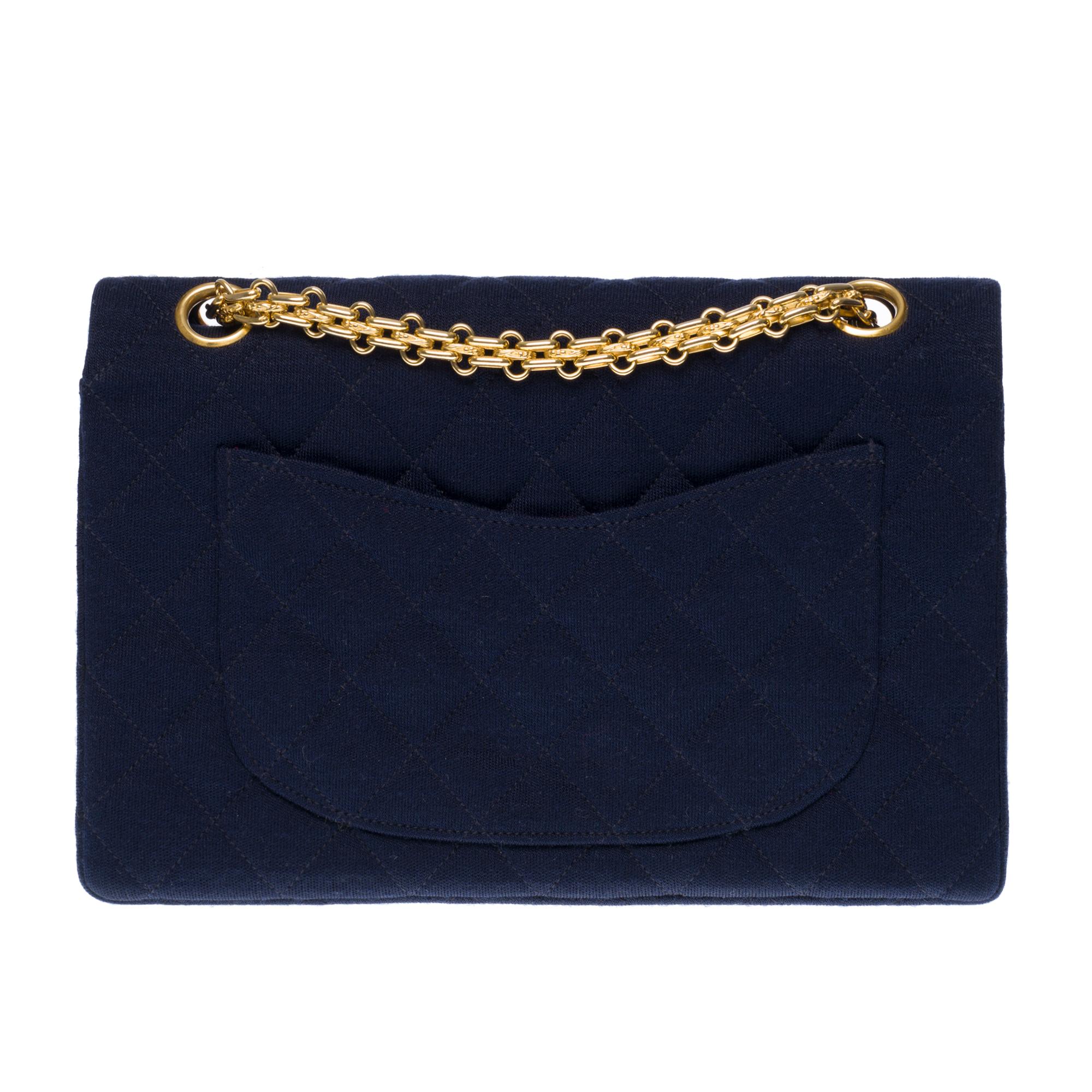 Superb Timeless/Classic bag with double flap in navy blue quilted jersey , gold metal hardware, Mademoiselle chain handle in gold metal allowing a hand or shoulder support.
Quilted flap closure, gold metal CC closure.
Lining in red canvas, a double