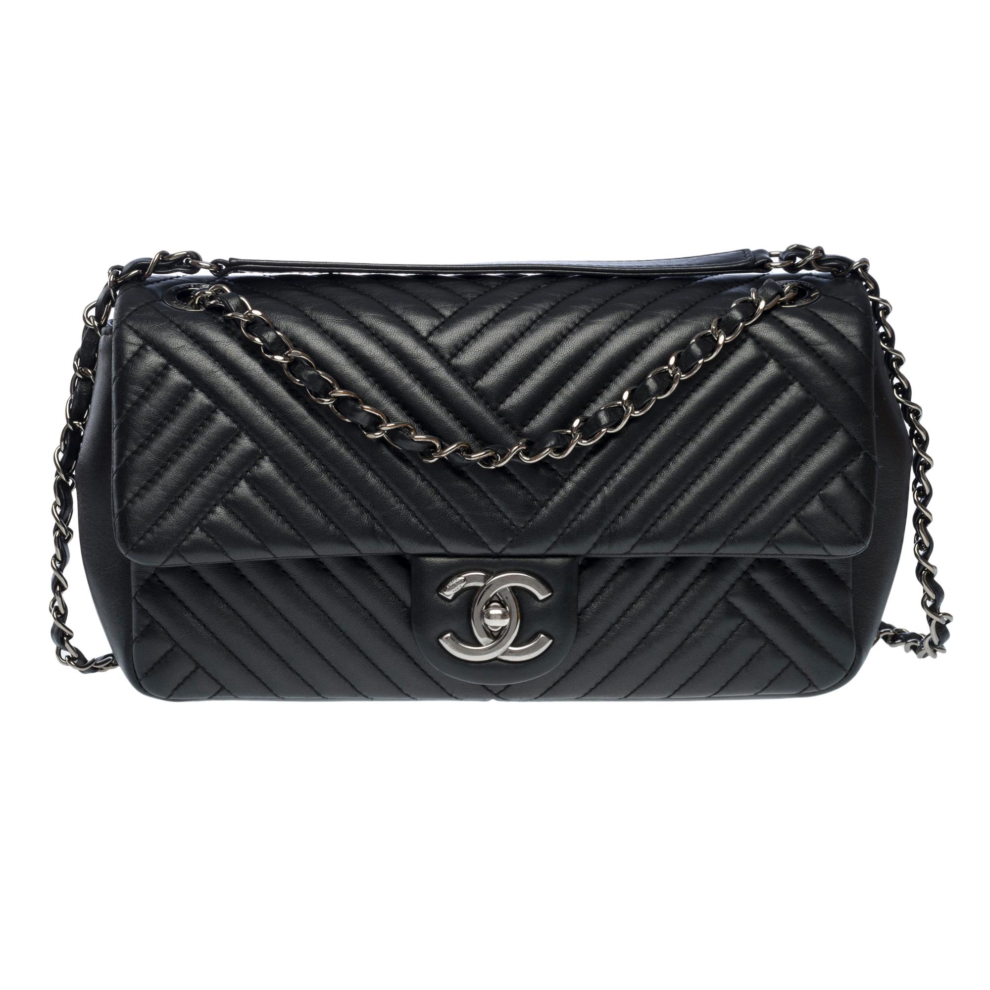 Exceptional and very Rare limited edition Chanel Timeless/Classic shoulder flap bag Medium in black asymmetrical lambskin leather with herringbone, ruthenium metal hardware, a ruthenium metal chain handle intertwined with black leather for carrying