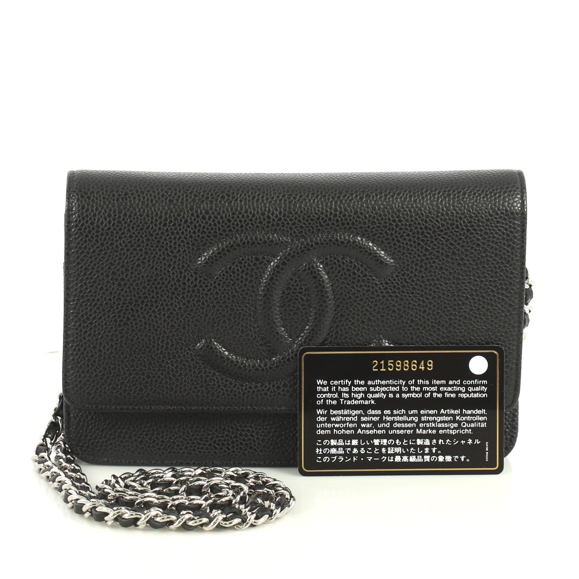 This Chanel Timeless Wallet on Chain Caviar, crafted in black caviar leather, features woven-in leather chain strap, interlocking CC logo stitched on front and silver-tone hardware. Its snap button closure opens to a black leather interior with