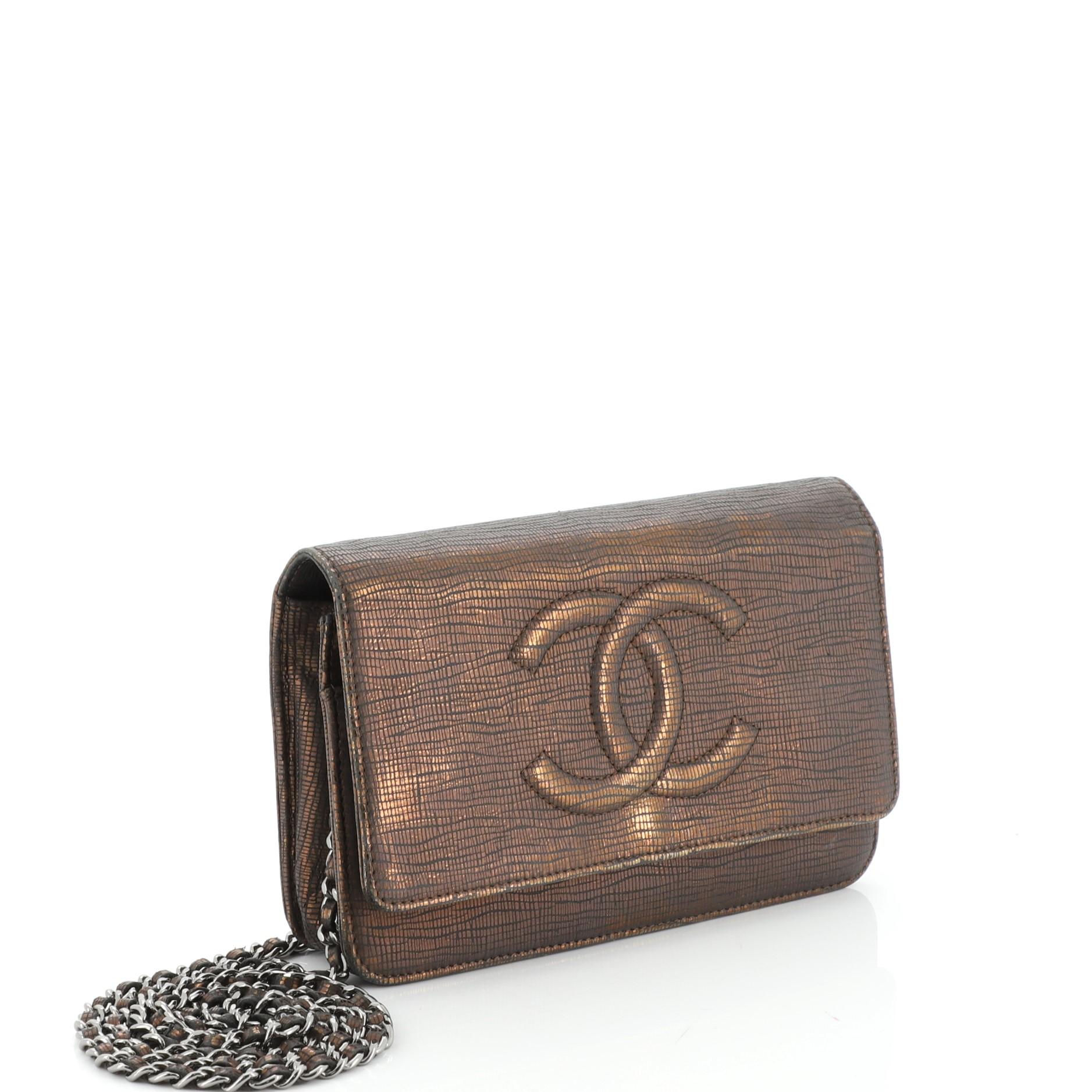 This Chanel Timeless Wallet on Chain Textured Leather, crafted in metallic brown textured leather, features woven-in leather chain strap, interlocking CC logo stitched on front and silver-tone hardware. Its snap button closure opens to a black