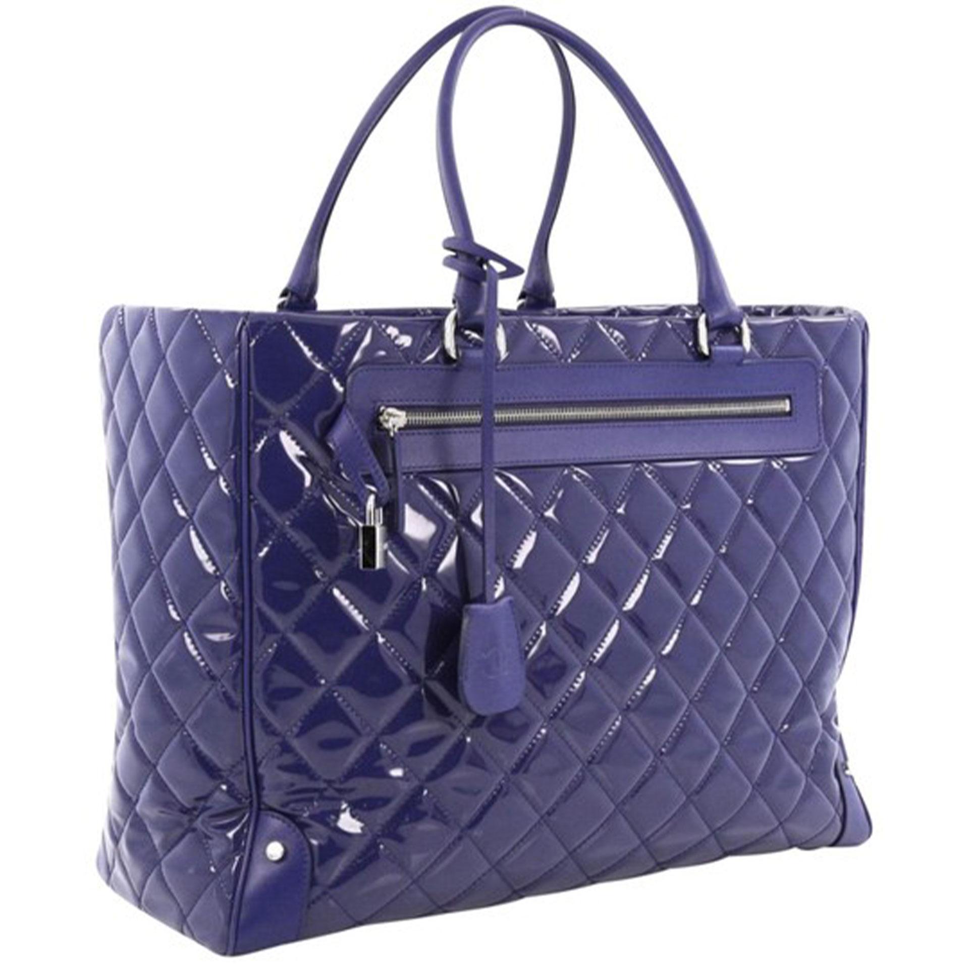 Chanel Royal Blue Patent Leather XL Quilted Carry-On Travel Bag Tote 

Spring/Summer 2015 
Silver hardware
Royal blue patent leather
Royal blue calfskin leather trims
Dual-rolled leather handles
Exterior zip pocket with a padlock and a hanging