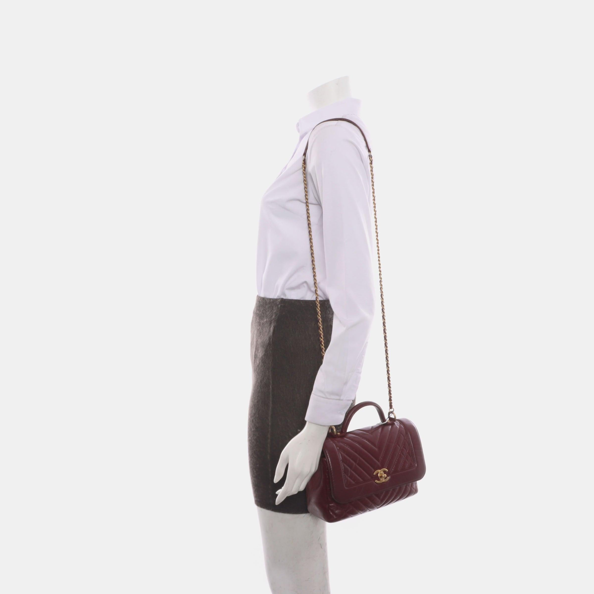 Chanel Top Handle Chevron Flap Bag Mini Burgundy Calfskin Leather, 2017
 These are professional photos of the actual bag.
 CONDITION: VERY GOOD
 This preloved / preowned Chanel top handle bag is in very good condition. Light rubbing around the