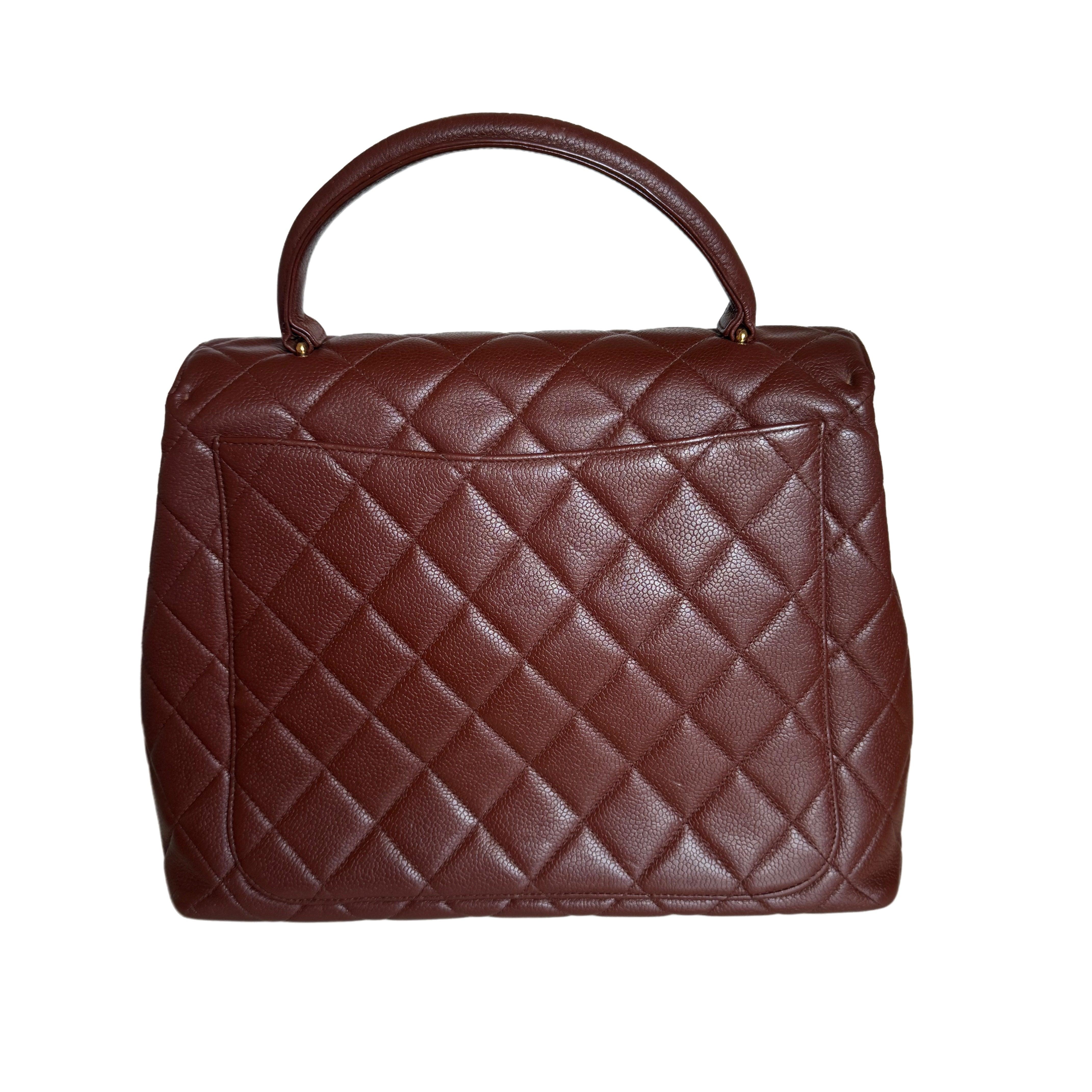 Chanel Vintage Top Handle Kelly Dark Caramel Flap Bag Caviar Leather 24k Gold Plated Hardware, 2000-2002
These are professional photos of the actual bag.
  Unleash your inner icon with this exquisite Vintage Chanel Dark Caramel Quilted Caviar Top