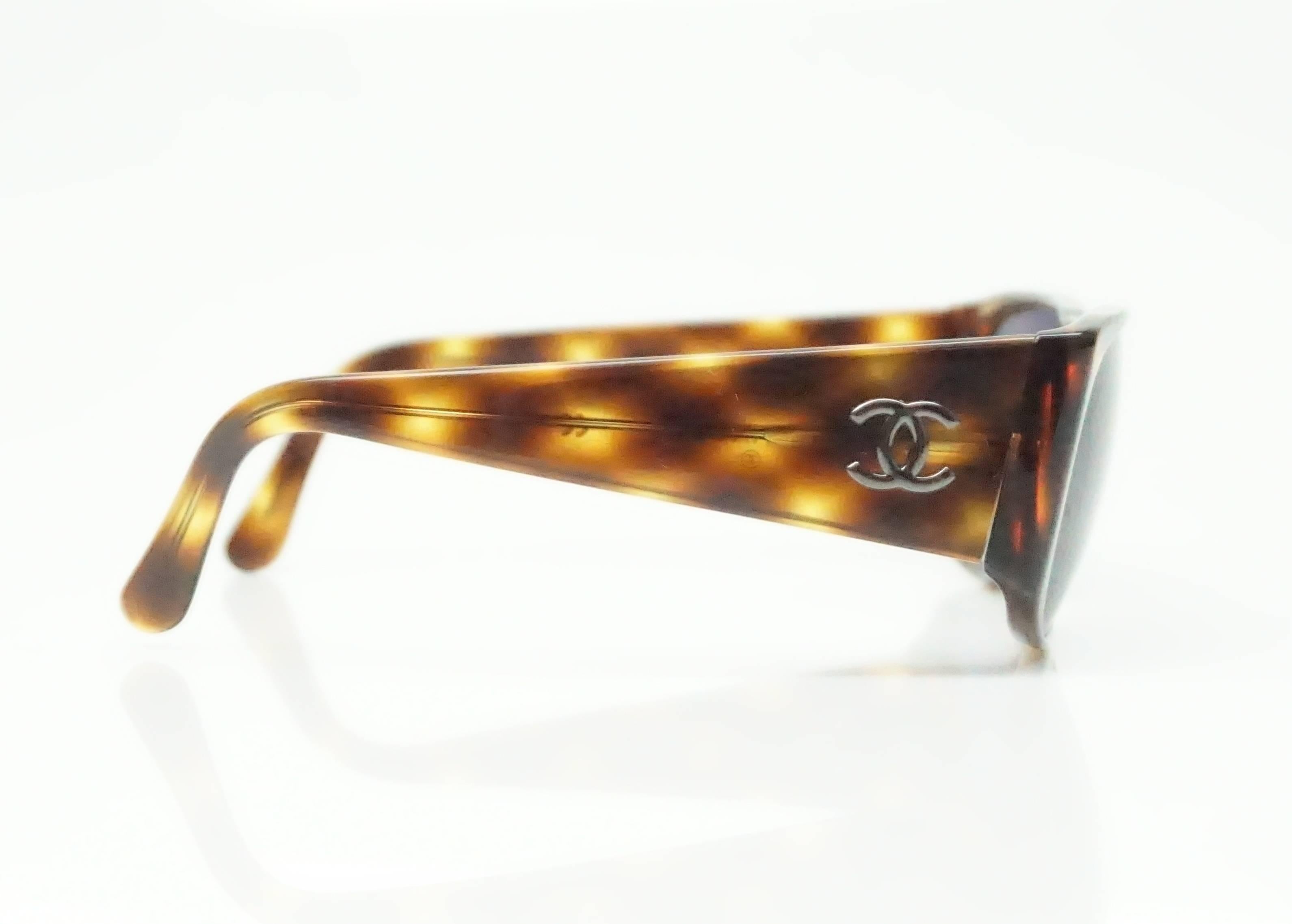 Chanel Tortoise Shell Sunglasses w/ Silver CC Logo  These beautiful Chanel sunglasses are in excellent condition.  There is a slight opening in the middle of the glasses and the tortoise print is carried throughout the glasses. 
Measurements
Front: