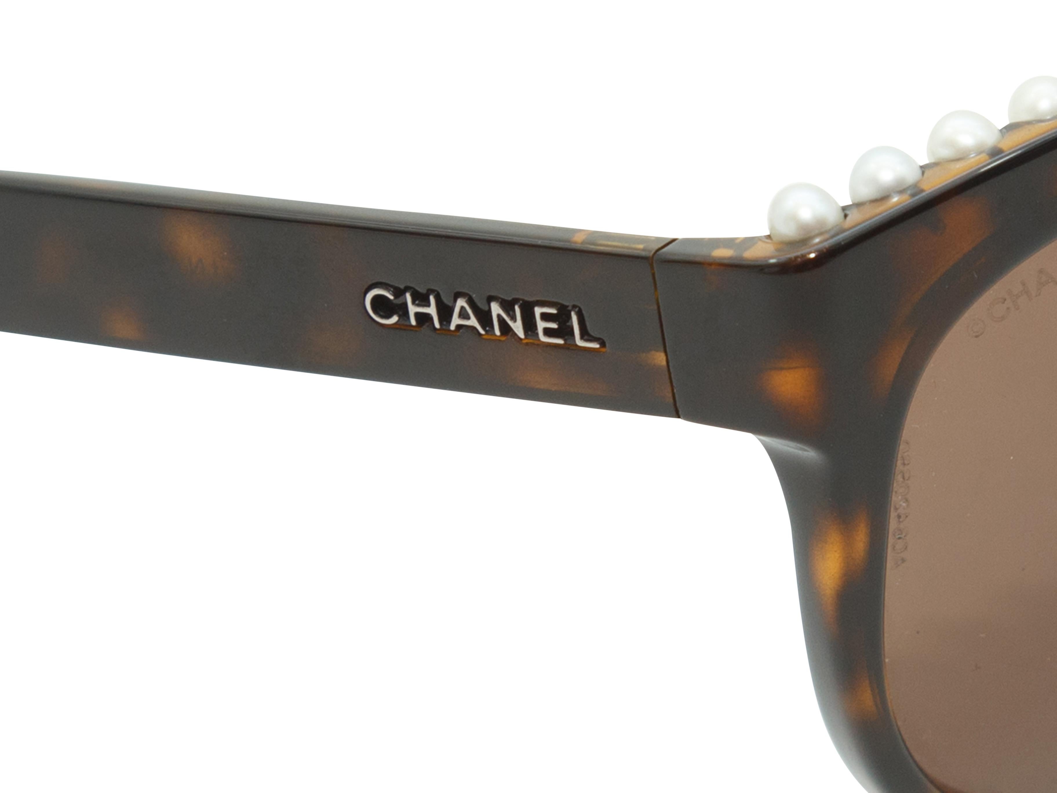 Product details: Tortoiseshell Chanel Pearl Trim Butterfly Shaped Sunglasses.  A line of pearls are perched on the top of the sunnies. The lenses are amber. Measurements: 5.5