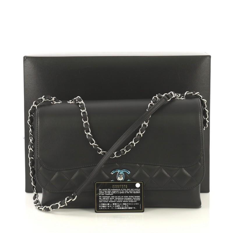 This Chanel Tramezzo Flap Bag Calfskin Jumbo, crafted in black calfskin leather, features woven in leather chain link strap with leather pad, exterior back slip pocket, and silver-tone hardware. Its CC turn-lock closure opens to a black fabric