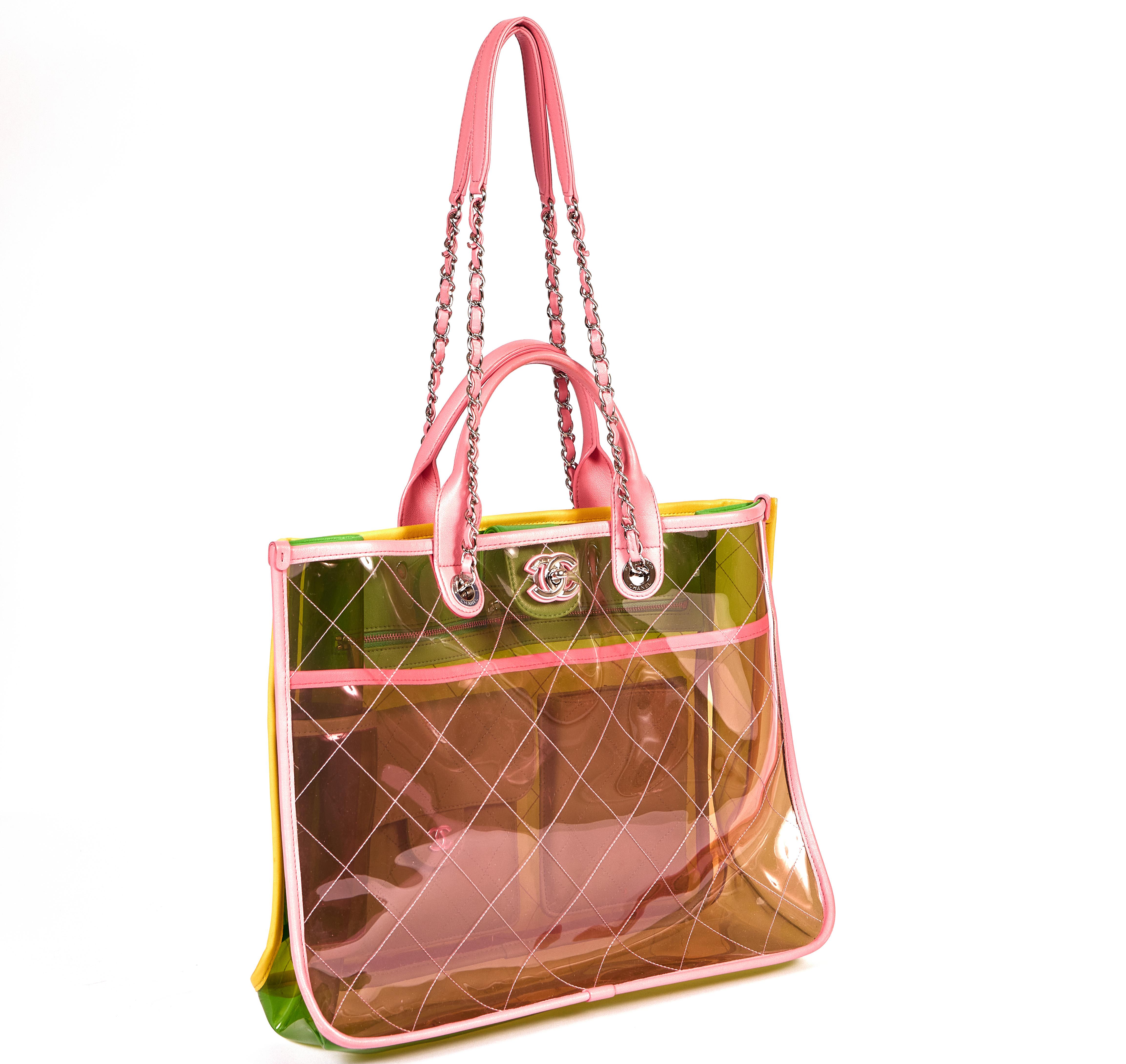 This large transparent PVC Chanel Coco is trimmed in leather lambskin and comes with two short toting handles as well as two long chain and leather straps. The bag is pink, green and yellow and an absolute must have for the summer. It comes with the
