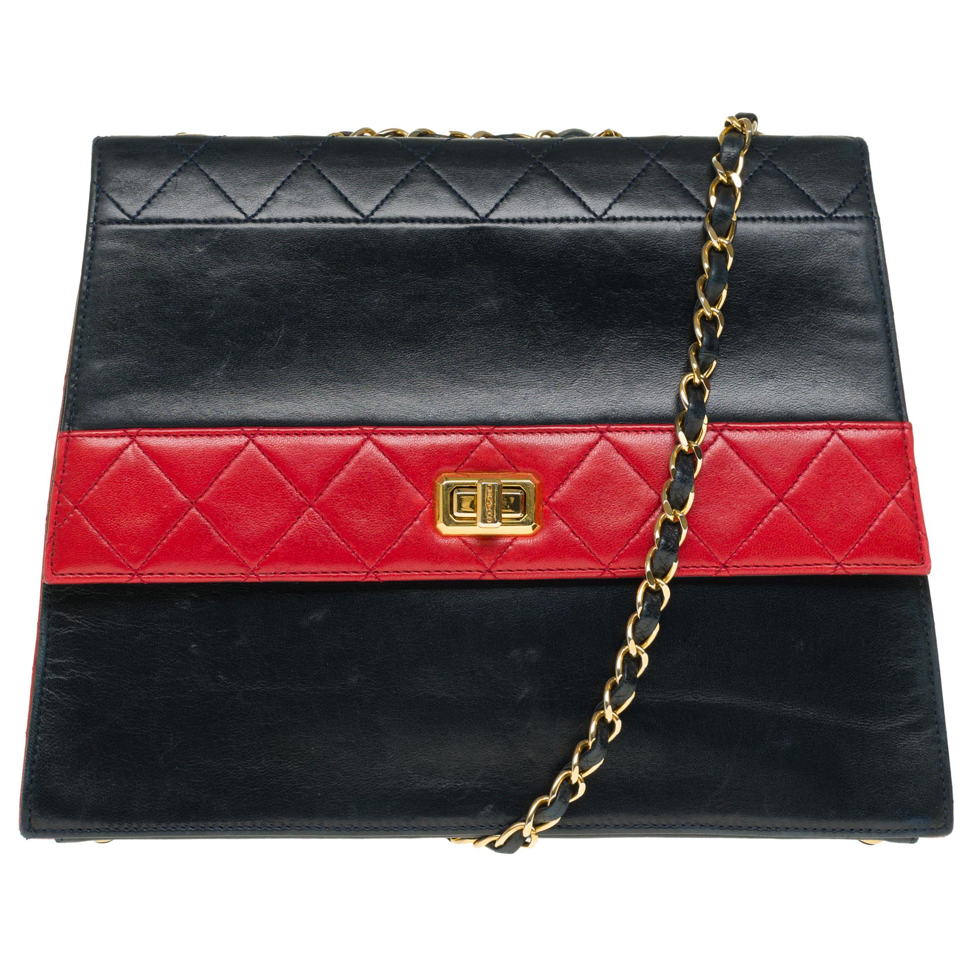 Gorgeous & Rare Chanel Trapezoidal shoulder flap bag in partially quilted navy blue and red leather, gold-tone metal hardware, a gold-tone metal chain handle interwoven with navy leather for a shoulder and crossbody carry

A patch pocket on the back