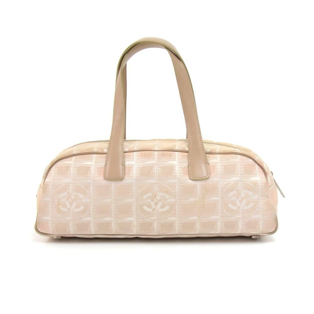 Chanel mini boston bag in beige jacquard nylon from the travel line. Outside has beige leather handles and piping. It is secured with a zipper closure and inside has a fabric lining with one zipper pocket.  Great for your daily needs! SKU: