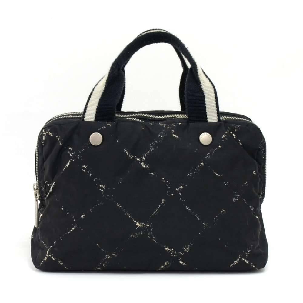 Chanel Travel line hand bag in black x White nylon. It has 3 separated compartment with zipper closures. Inside has vinyl water-repellant lining. Comfortably carried in hand. Great for storing your cosmetics and toiletries while you travel! SKU: