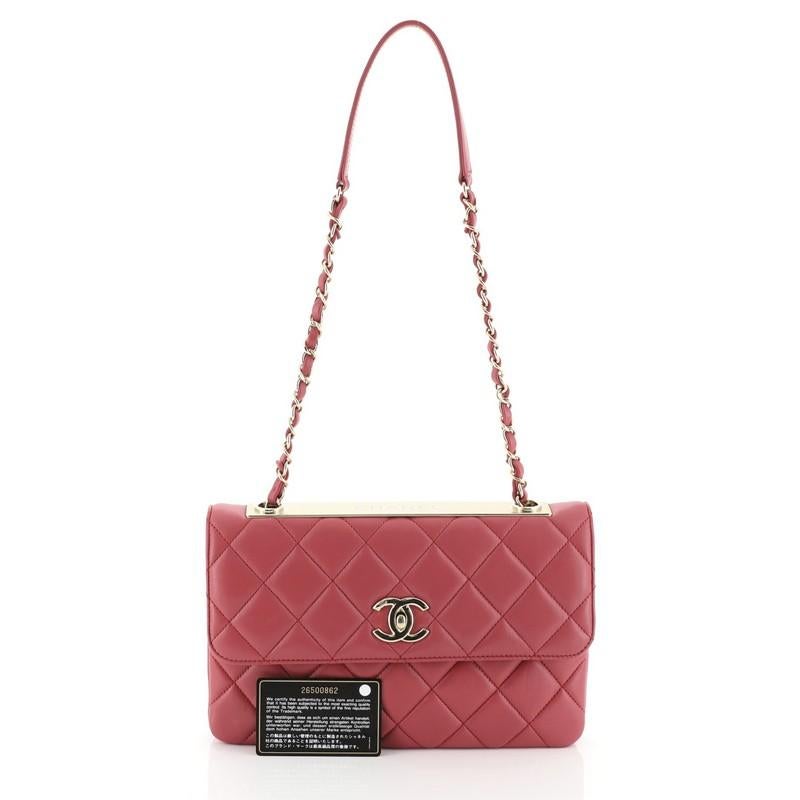 This Chanel Trendy CC Flap Bag Quilted Lambskin Medium, crafted from pink quilted lambskin leather, features woven-in leather chain strap with leather pad, metal plate on top, exterior back pocket, and gold-tone hardware. Its CC turn-lock closure