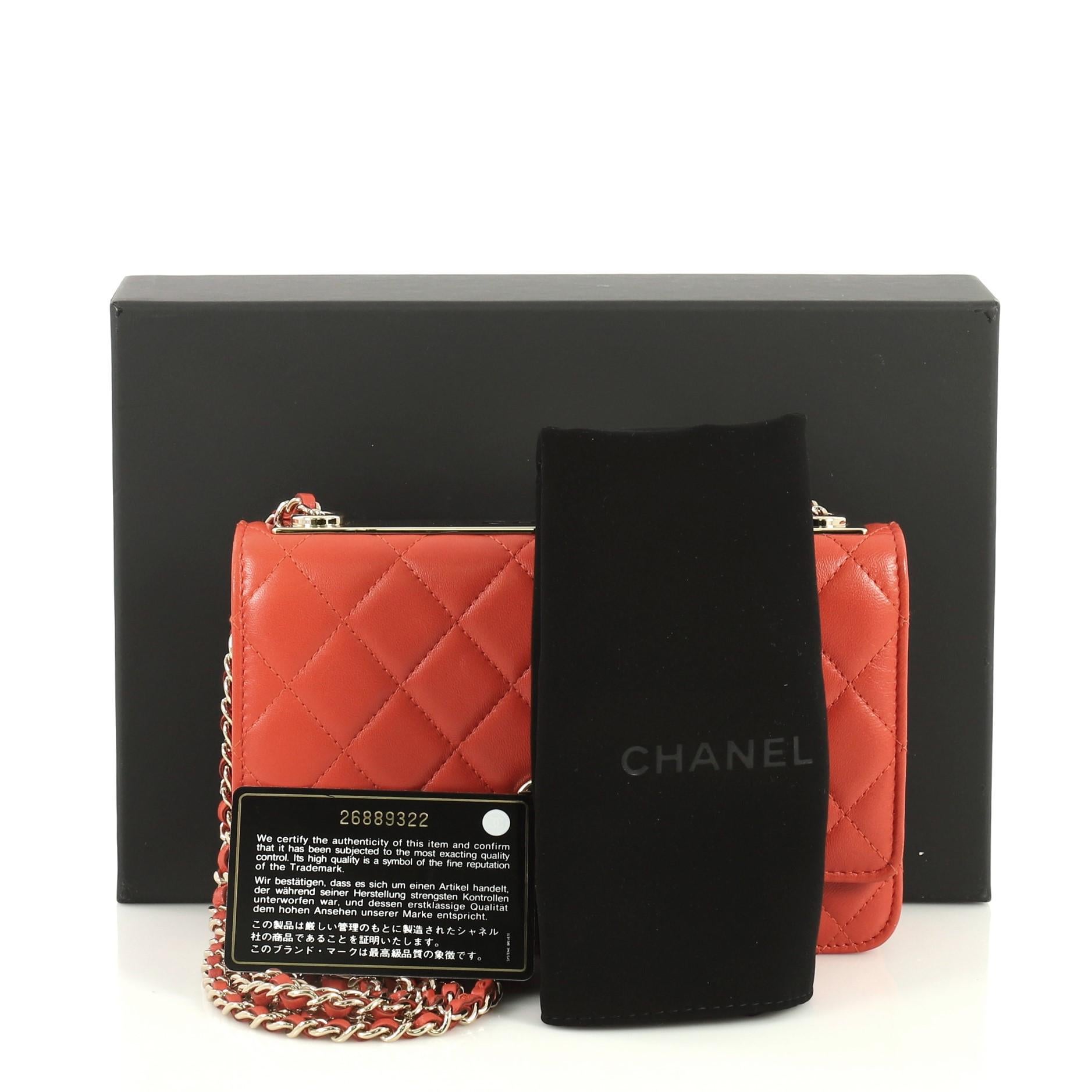 This Chanel Trendy CC Wallet on Chain Quilted Lambskin, crafted from orange quilted lambskin leather, features woven-in leather chain strap and gold-tone hardware. Its CC turn-lock closure opens to an orange leather and fabric interior with multiple