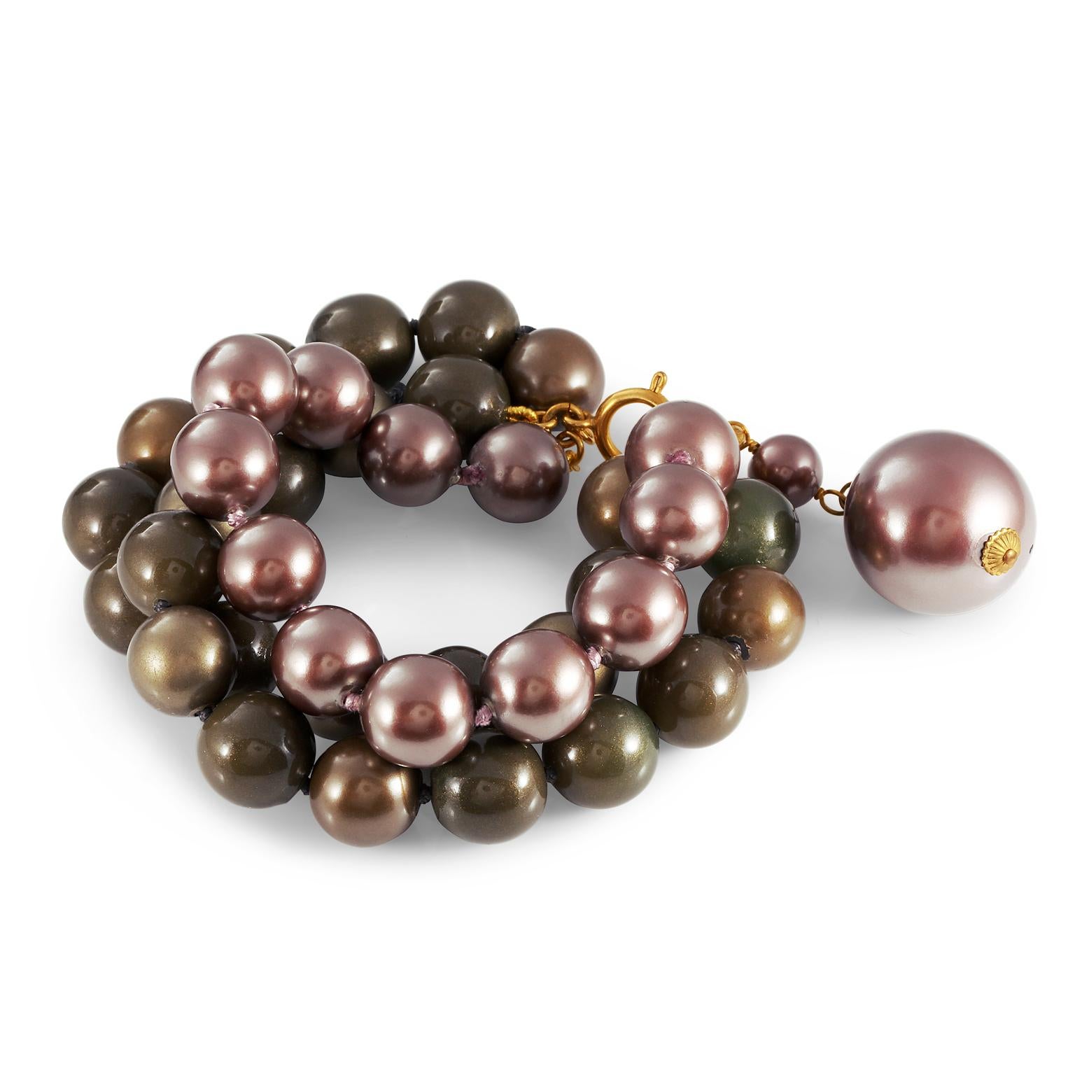 This authentic Chanel Tri Color Triple Row Bracelet is in excellent condition from the early 1990’s.  Three rows of beads create a beautiful statement piece.  Subtle metallic hues of burgundy, dark chocolate and dark gold. Spring hinge clasp with