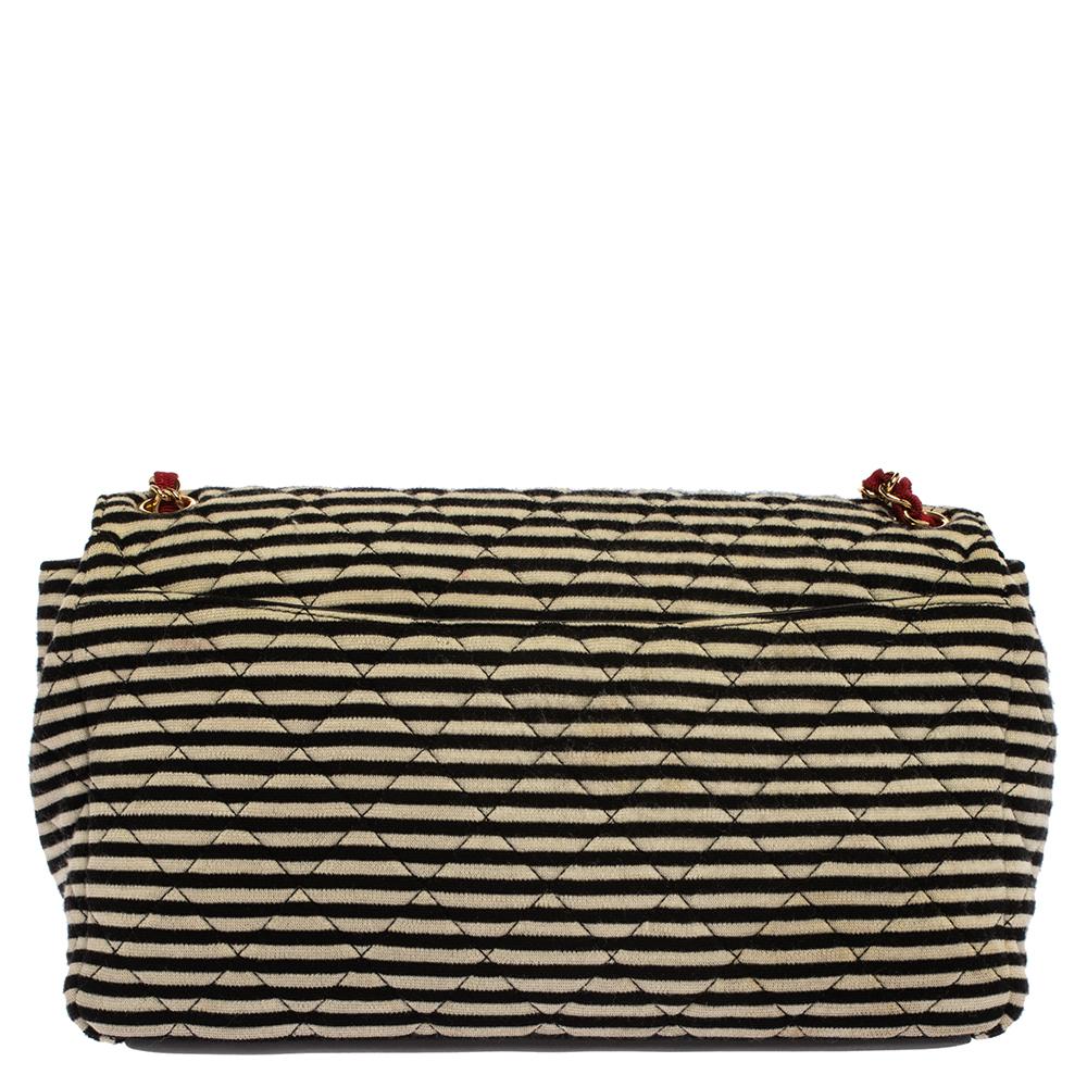 Add this beautiful Chanel Coco Sailer shoulder bag to your collection and carry the classic Chanel elegance with you at your day time and summer occasions. Crafted in black and white striped jersey fabric, this bag is accented with black leather