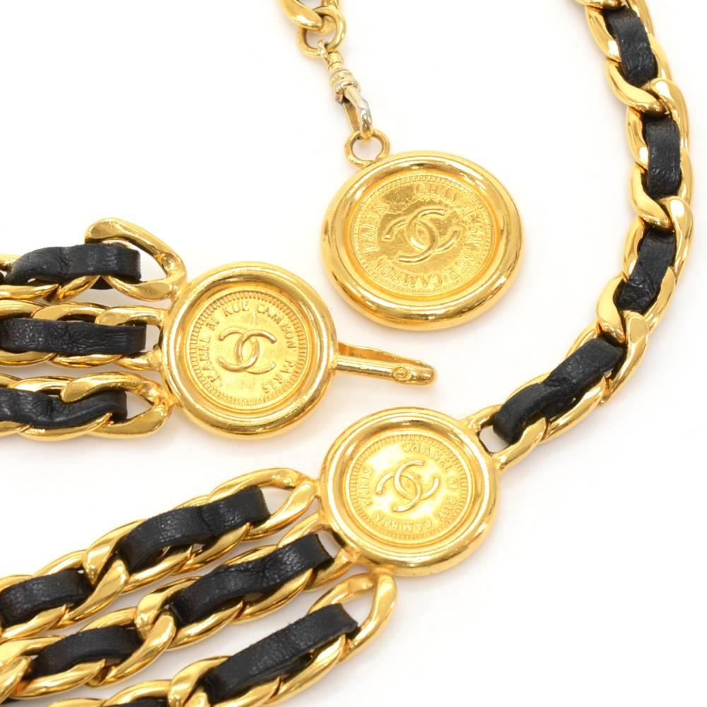 Chanel chain belt in black lambskin leather intertwined with gold tone brass chains.  Has a very stylish triple chain to go across the front of your pants, skirt, or dress. Has three gold-tone Chanel medallions with the CC logo and  