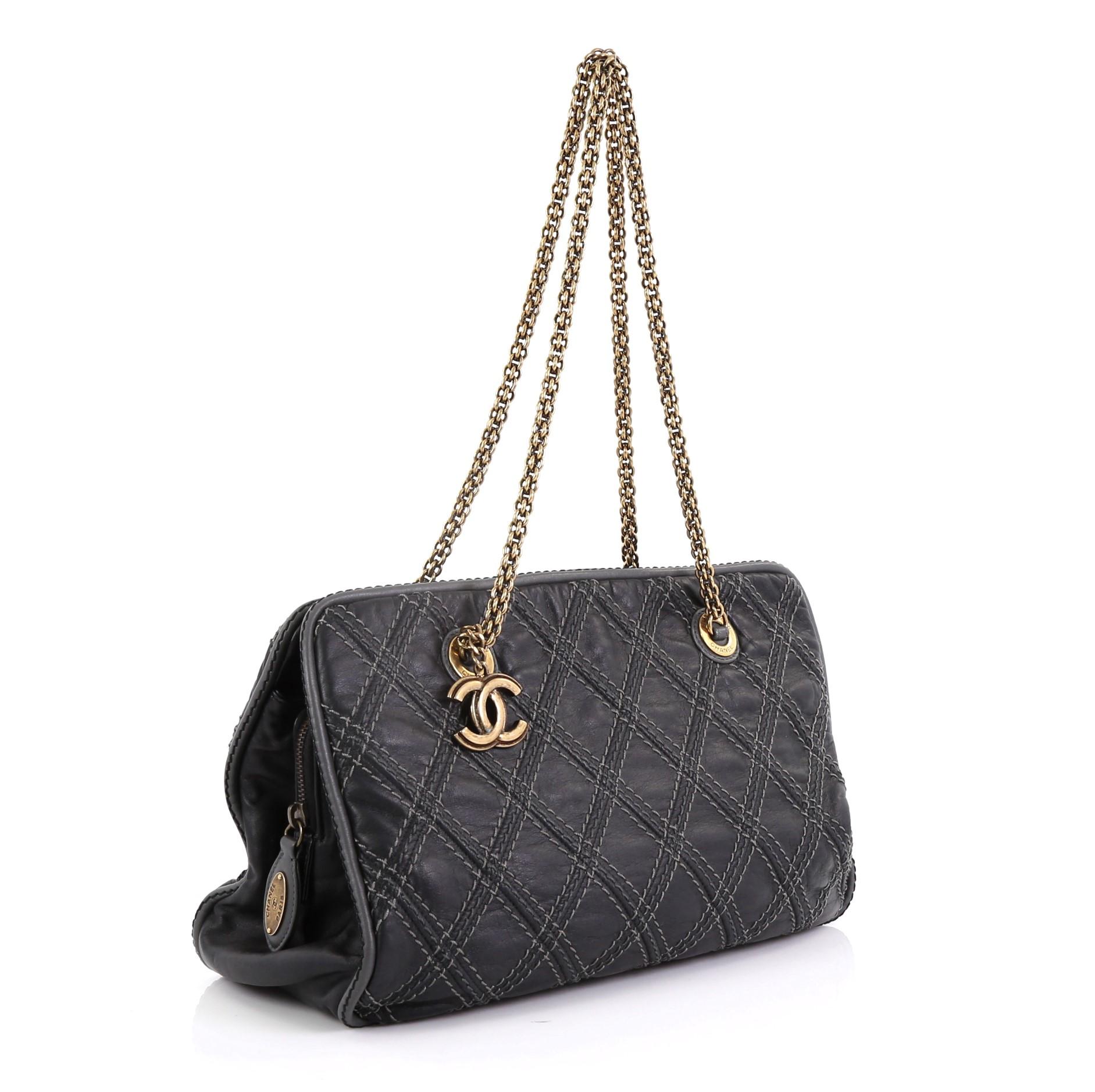 This Chanel Triptych Tote Quilted Calfskin, crafted in black quilted calfskin leather, features dual chain link straps and gold-tone hardware. Its zip closure opens to a gray satin interior with zip and slip pockets. Hologram sticker reads: