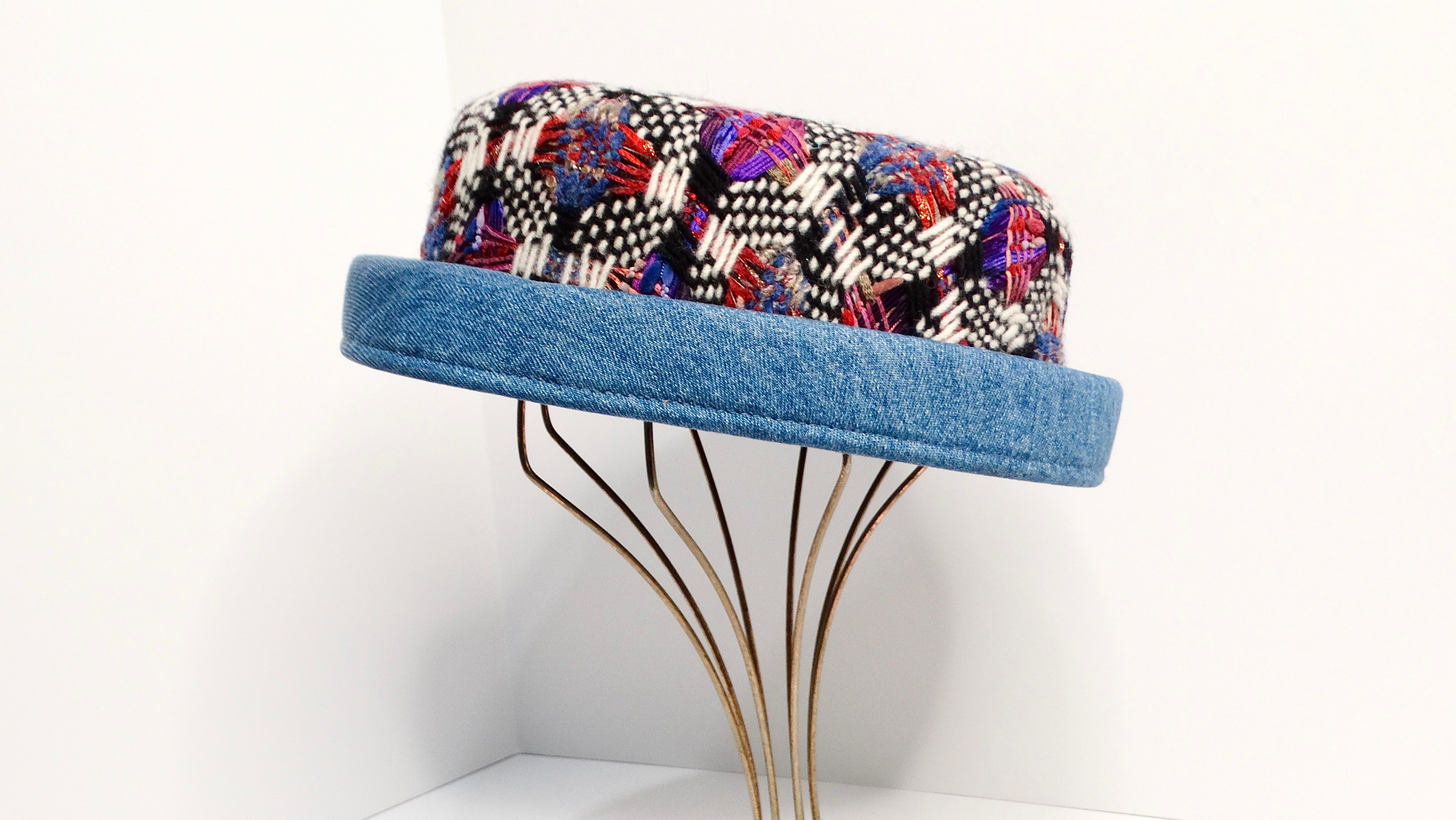 The Chanel Tweed and Denim Bowler Style Hat is a vibrant and stylish accessory that brings a touch of classic elegance and contemporary flair to any outfit. This hat features a colorful tweed design incorporating black, white, red, blue, purple, and