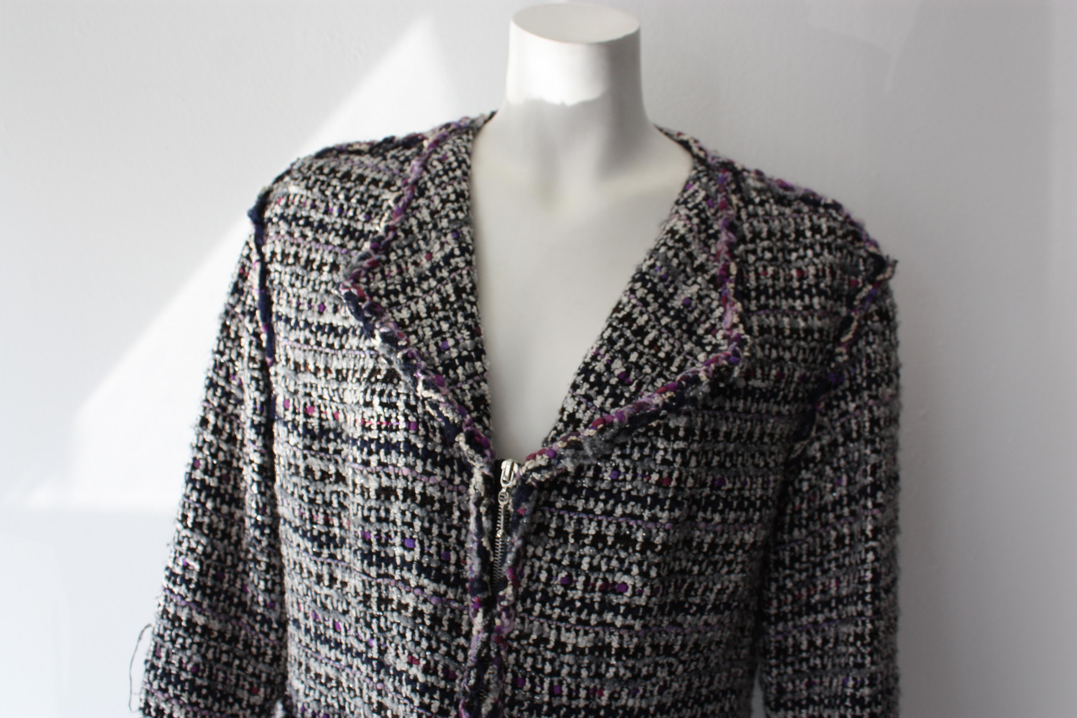 Chanel tweed blazer. Zip up and front waist pockets.
Purple, white and black tweed. 

66% wool, 18% nylon, 10% silk, 6% polyester. Lining: 100% silk.

Size 44 (fits smaller) 