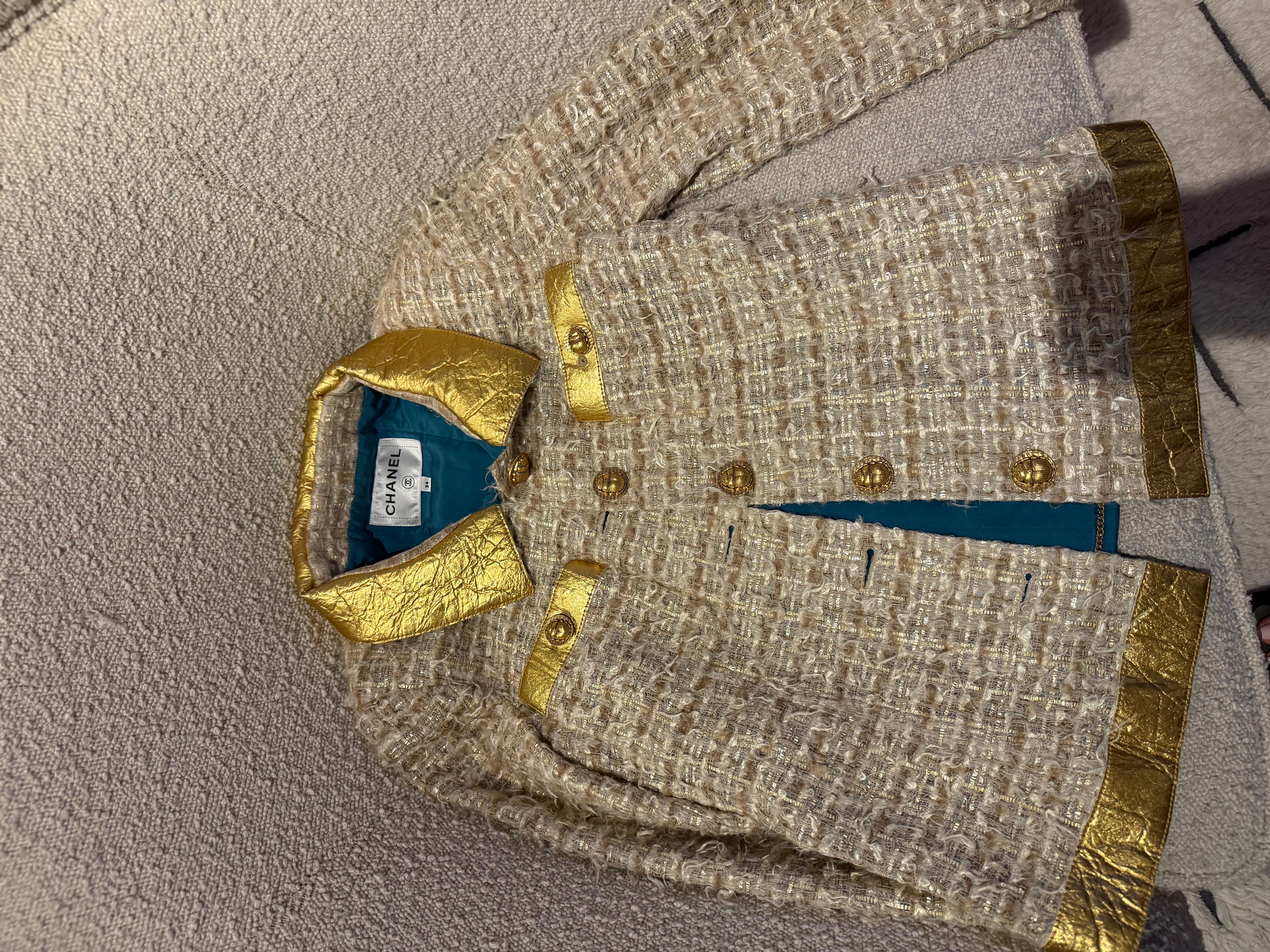 Iconic Chanel tweed jacket Look 5 from the Pre-Fall 2019 Métiers d'Art Runway  Egypt collection, PARIS - NEW YORK 2018/19 MÉTIERS D'ART COLLECTION. Known as the 
