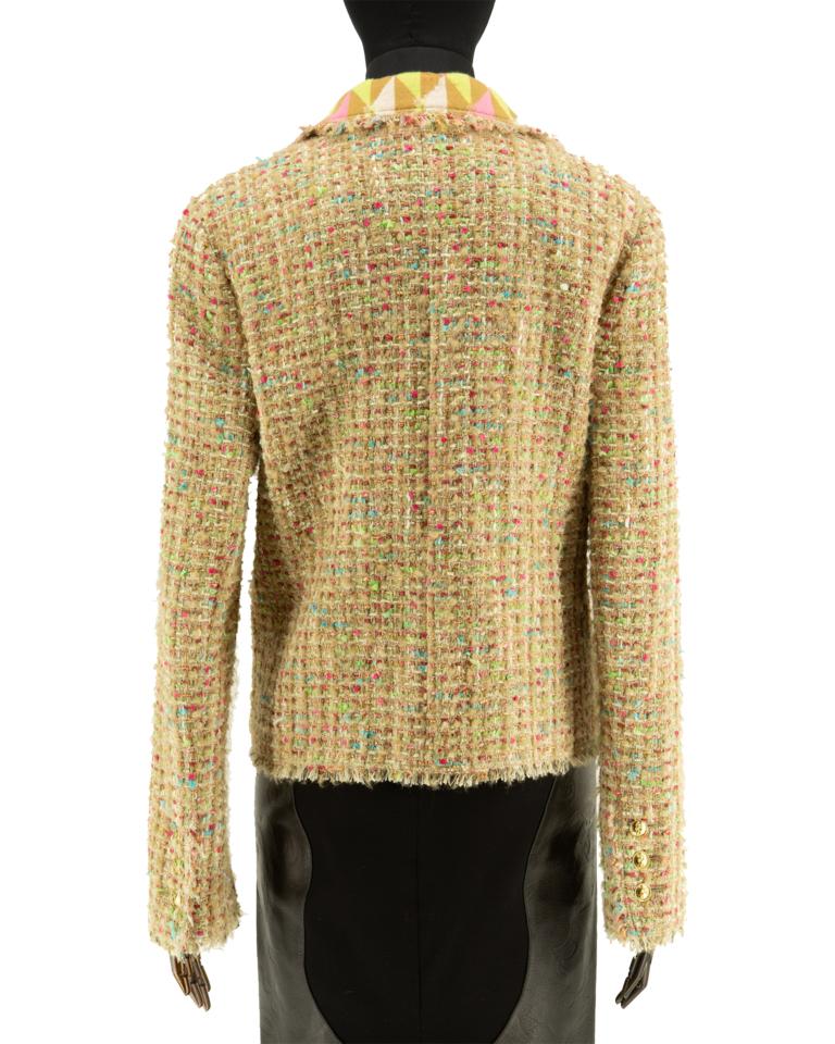Chanel jacket In the classic tweed in beige with bright pops of blue-green and pink. The jacket is fully lined in geometric diamond design on jersey which extends to the collar and decorative pocket facings, with signature frayed tweed edges