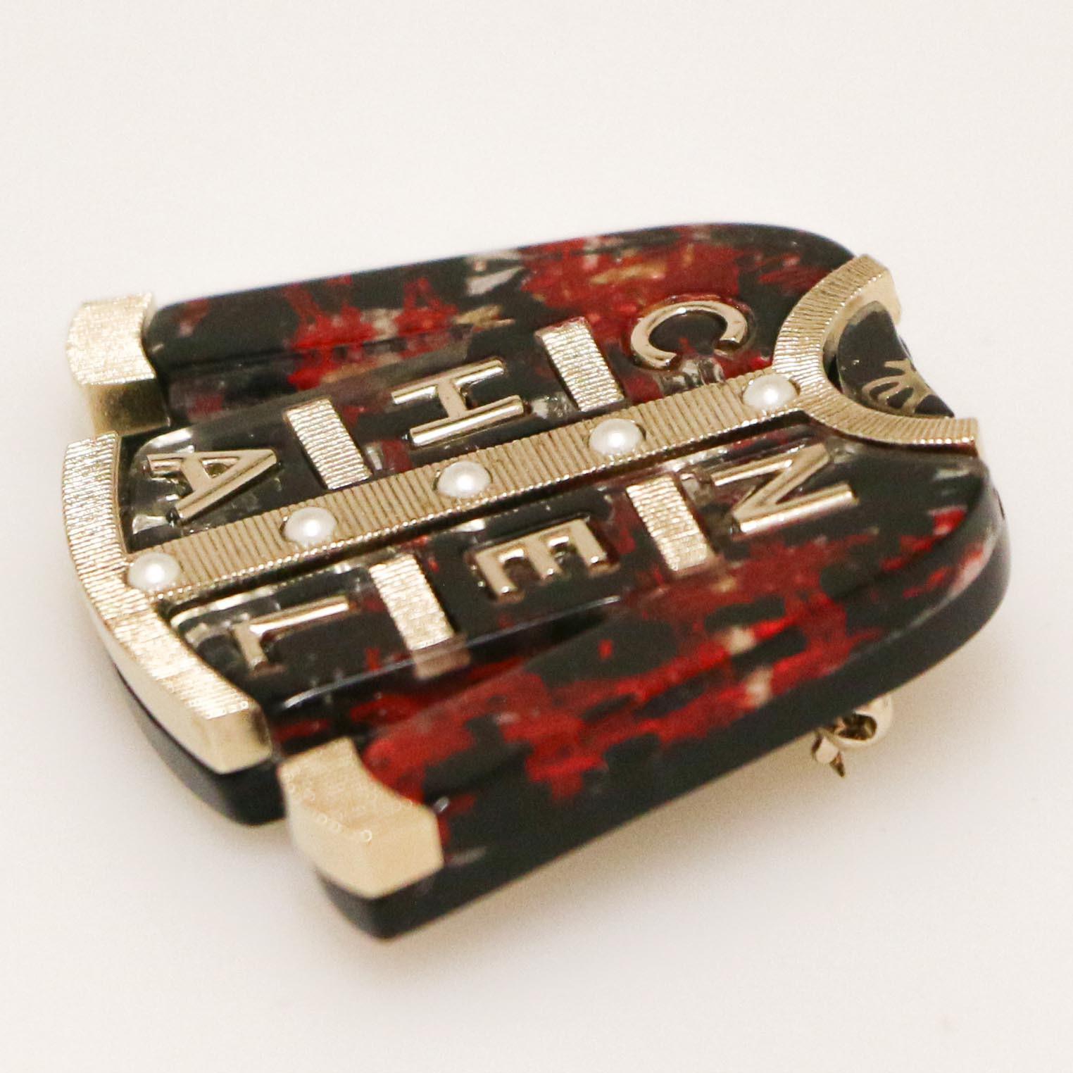 CHANEL Tweed Jacket  C H A N E L Brooch in gilt metal, black and red resin, pearls beads.
In very good condition
Made in Italy.
Size: 5.8 x 5.4cm
Stamp: yes - Collection P 2011.
Will be delivered in a CHANEL dustbag,