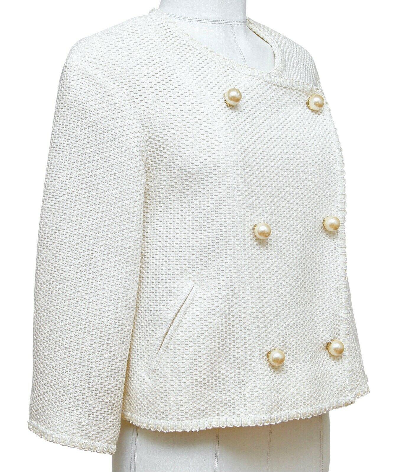 GUARANTEED AUTHENTIC CHANEL 2013 SPRING COLLECTION EXQUISITE WHITE TWEED JACKET W/FAUX PEARLS

Retailed excluding sales taxes $4,920
Details:
• Signature cut and fit on this unique white double breasted jacket closure.
• Faux pearl buttons, actual