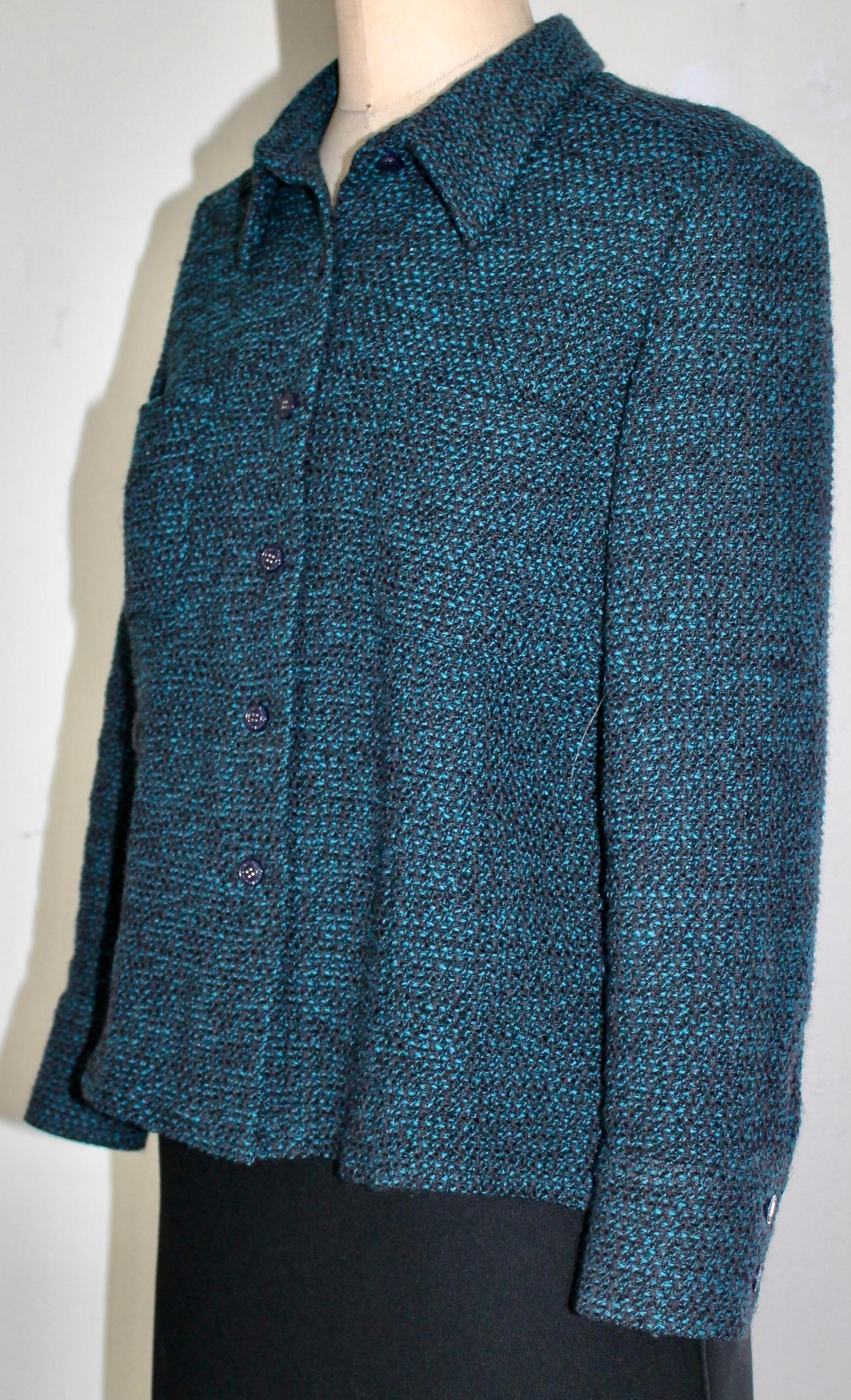 A blue Green Tweed Jacket 21c. Silk lining at top of back only. Slightly padded shoulders with 6 Chanel Buttons on the front and two on the cuffs. Fully labeled.