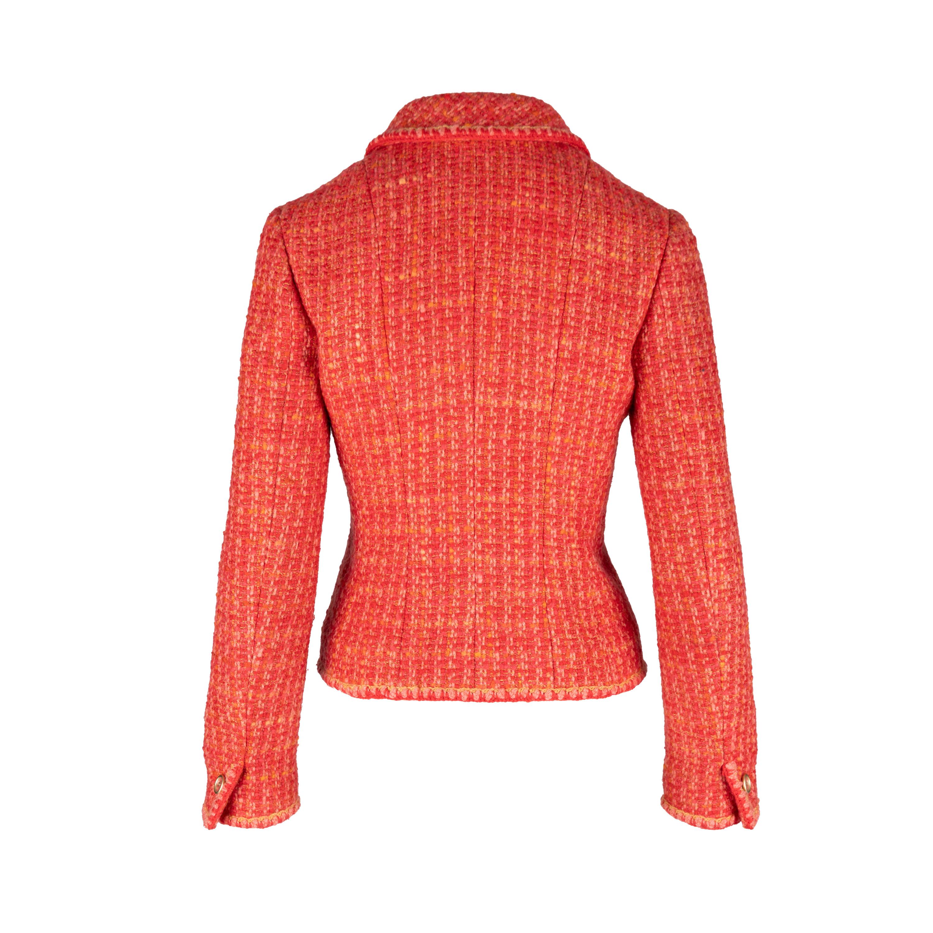 This classic tweed Chanel jacket is tailored for a slim fit, crafted in vivid red wool tweed and adorned with iconic transparent buttons featuring the CC logo. The jacket is further decorated with camelia printed silk lining, notched lapels, and