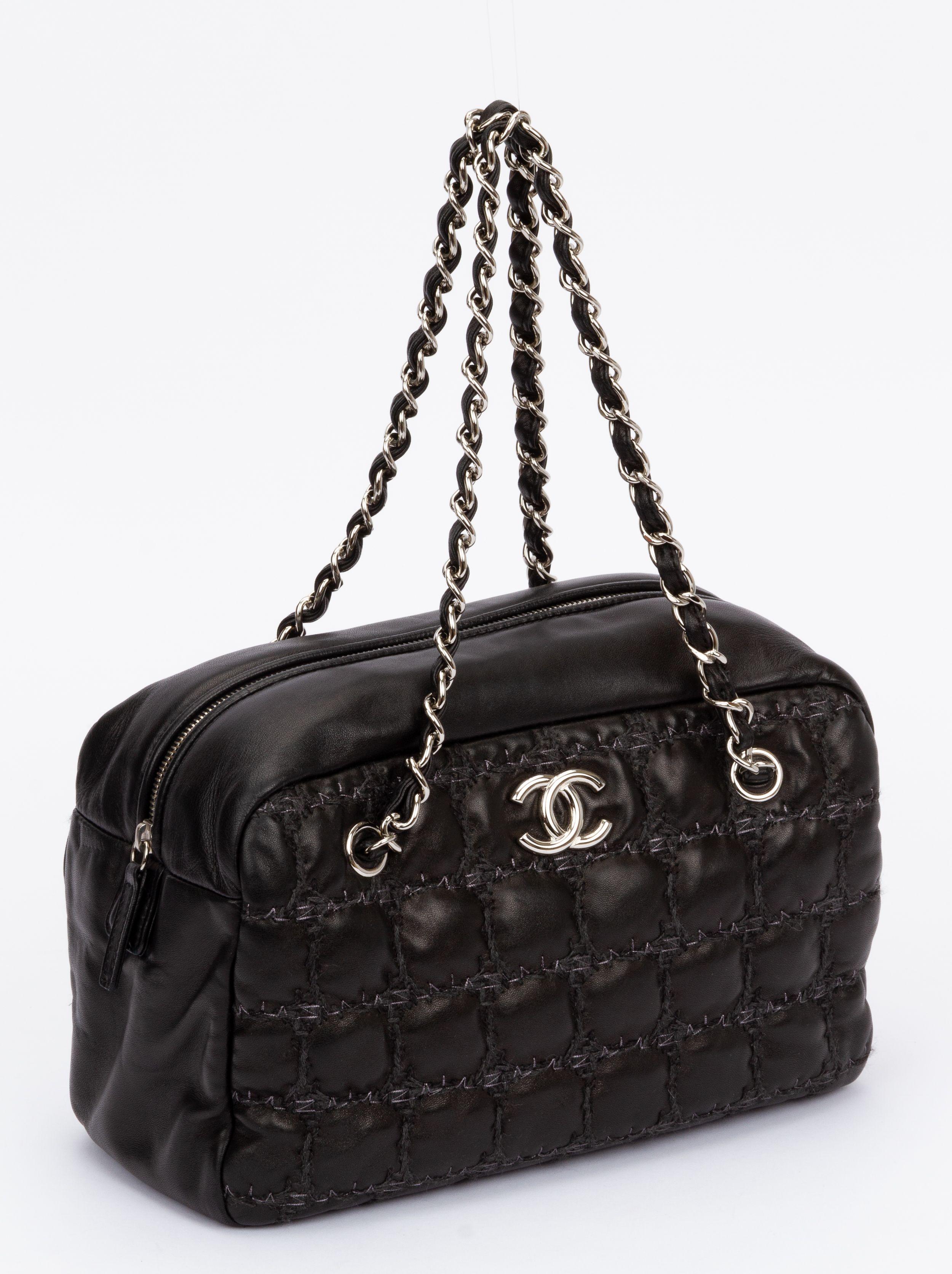 Chanel tweed on square stitch bubble bowler bag crafted of lambskin. Comes with silver hardware and a shoulder strap (drop 8'). On front of the bag is a CC logo. The interior is grey made of satin. The bag has the authenticity hologram and card as
