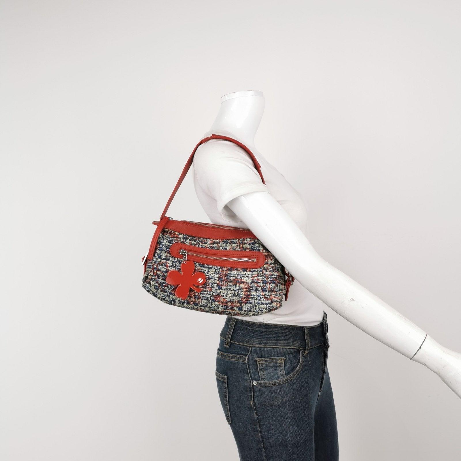 Chanel Tweed with Red Clover Charm Shoulder Bag These are professional photos of the actual bag offered by Luxbags. This classic Red Chanel Tweed Clover Shoulder Bag combines practicality and luxury with its front zip pocket and clover charm, made